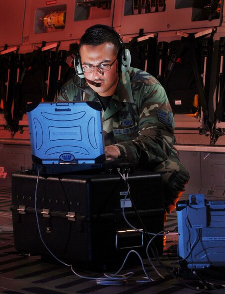 Staff Sgt. Carlos A. Rocha updates software for the missile warning system onboard a C-17 Globemaster III at March Air Reserve Base, Calif. He is an electronic warfare technician from the 452nd Maintenance Squadron here. (U.S. Air Force photo/Val Gempis)
