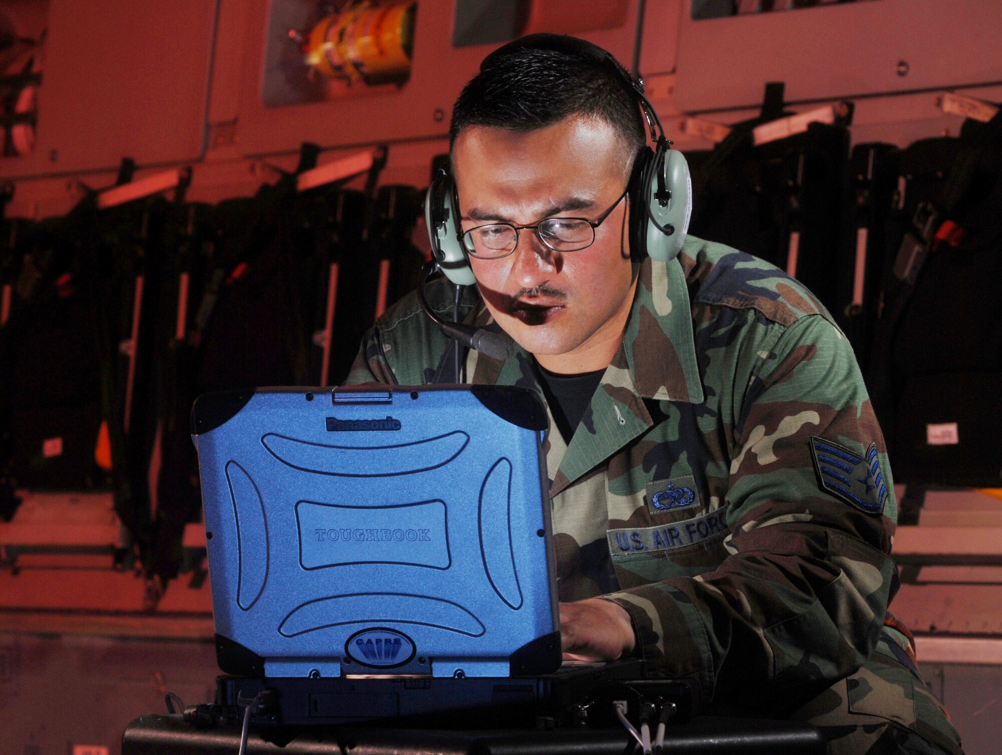 Staff Sgt. Carlos A. Rocha updates software for the missile warning system onboard a C-17 Globemaster III at March Air Reserve Base, Calif. He is an electronic warfare technician from the 452nd Maintenance Squadron here. (U.S. Air Force photo/Val Gempis)