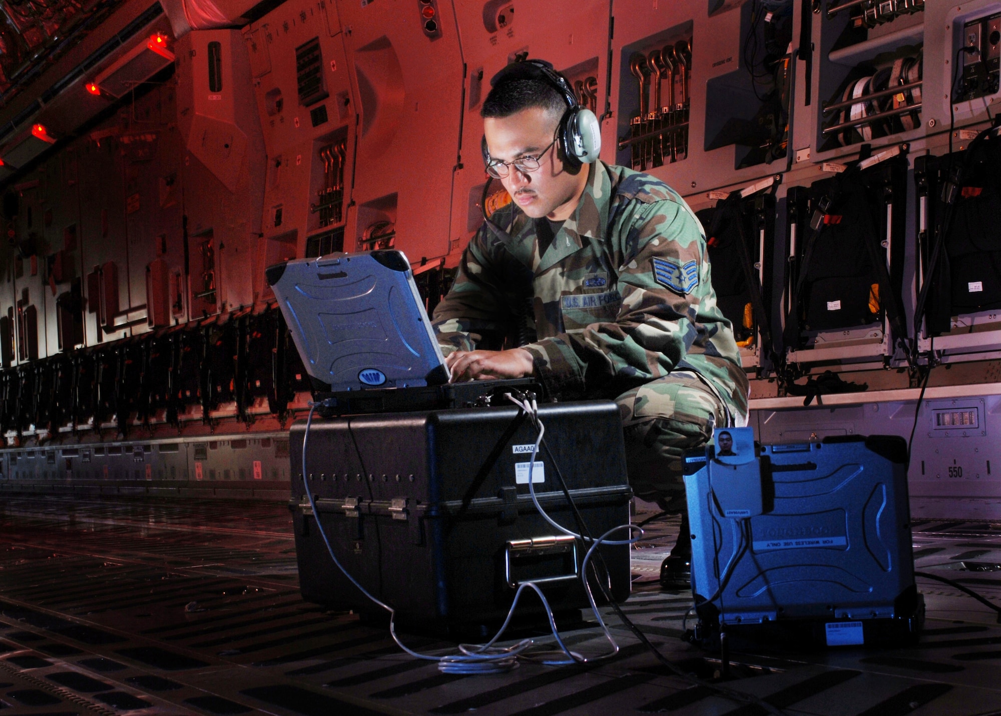 Staff Sgt. Carlos A. Rocha updates software for the missile warning system onboard a C-17 Globemaster III at March Air Reserve Base, Calif. He is an electronic warfare technician from the 452nd Maintenance Squadron here. (U.S. Air Force photo/Val Gempis)