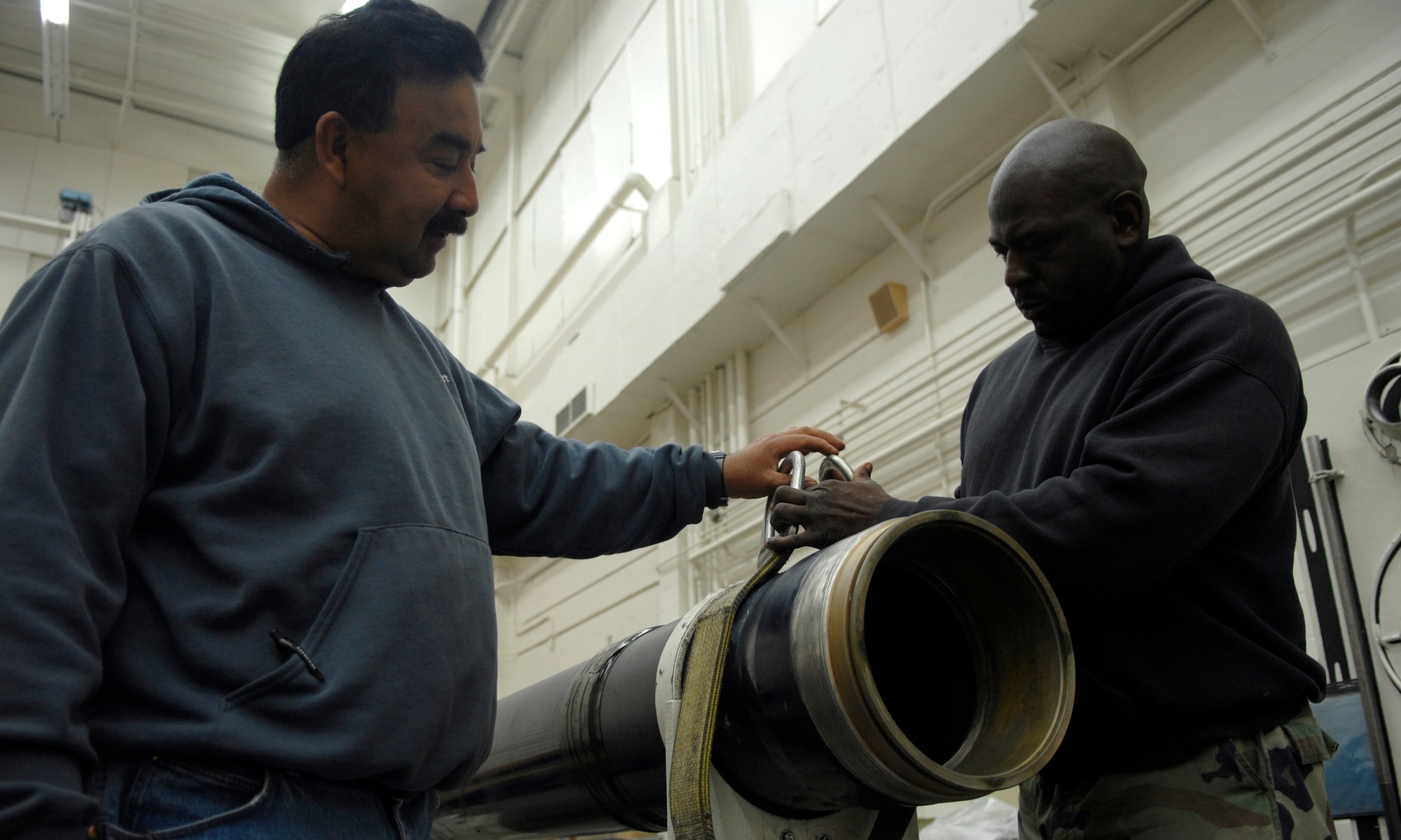 VANDENBERG AIR FORCE BASE, Calif., -- Ray Brown (right) and Frank Amadaor, both ordanance equipment engineers of the 581st Missile Maintenance Squadron, secure a dismantled ballistic actuator here June 16. The ballistic actuator is used to quickly open the launch enclosure during Minuteman III training launches here. (U.S. Air Force photo / SrA Christopher Hubenthal)