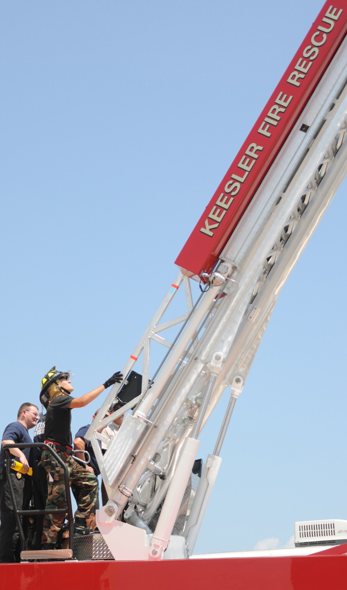 Firefighters Ron Davis and Airman 1st Class Ron Born train on the fire department’s new ladder truck June 9.  (U.S. Air Force photo by Kemberly Groue)