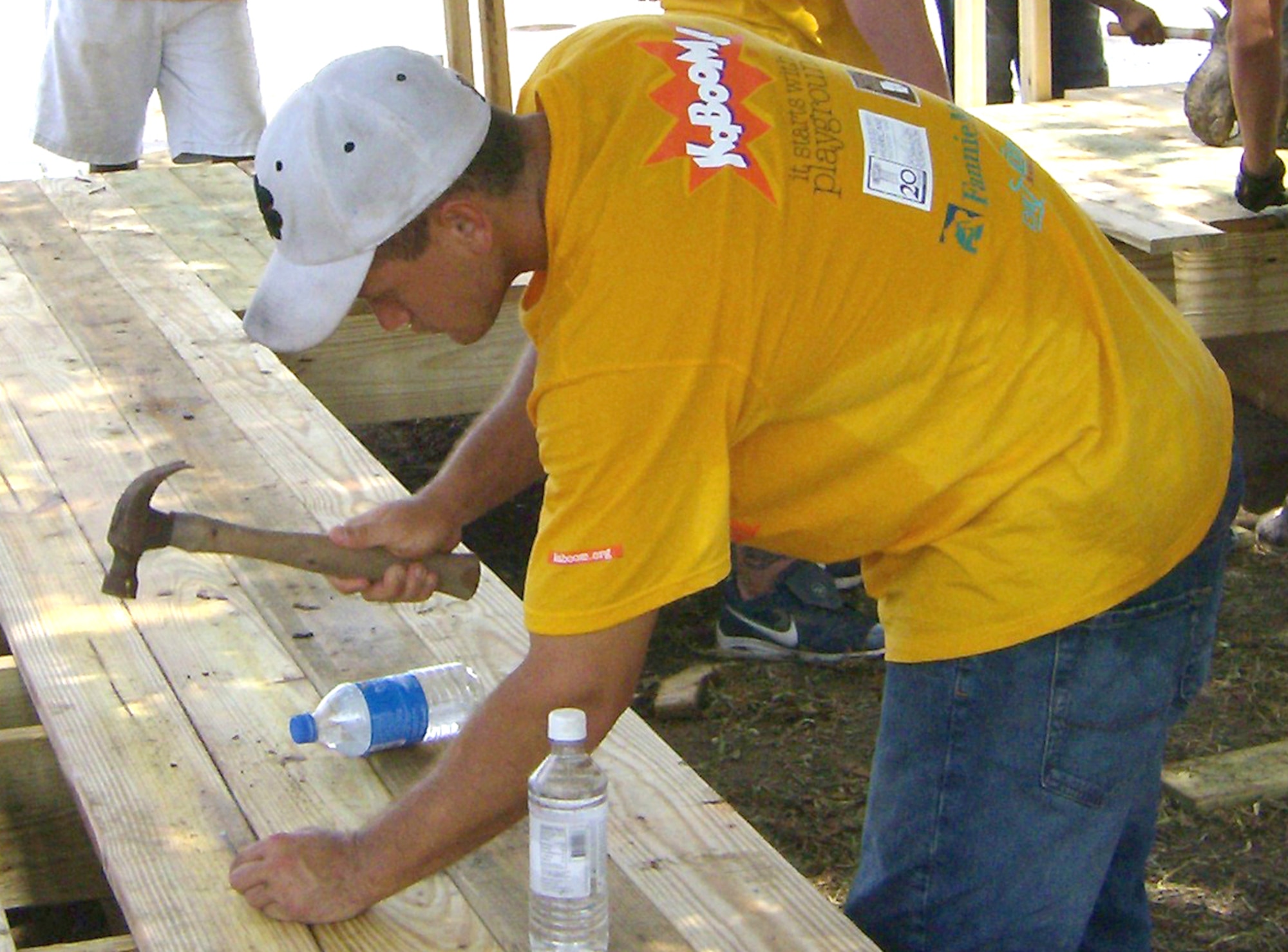 Right, Airman Basic Sean Souza nails a board onto a porch for parents to watch children play in the rebuilt park.  The playground was No. 100 for KaBoom!, a national nonprofit organization that pledged to build 100 playgrounds in areas affected by Hurricanes Katrina and Rita.  (U.S. Air Force photo by Lt. Col. Stephen Ramsay)