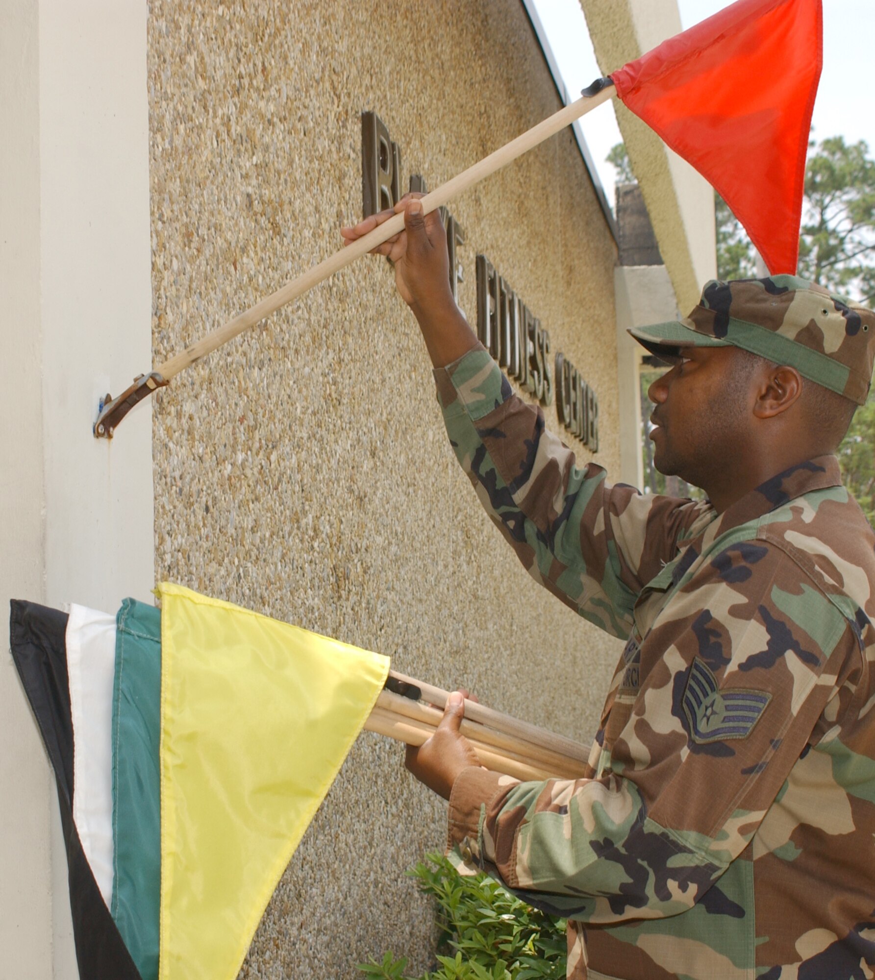 Darryll Stewart, 81st Force Support Squadron, posts a heat flag outside Blake Fitness Center.  (U.S. Air Force photo by Kemberly Groue)