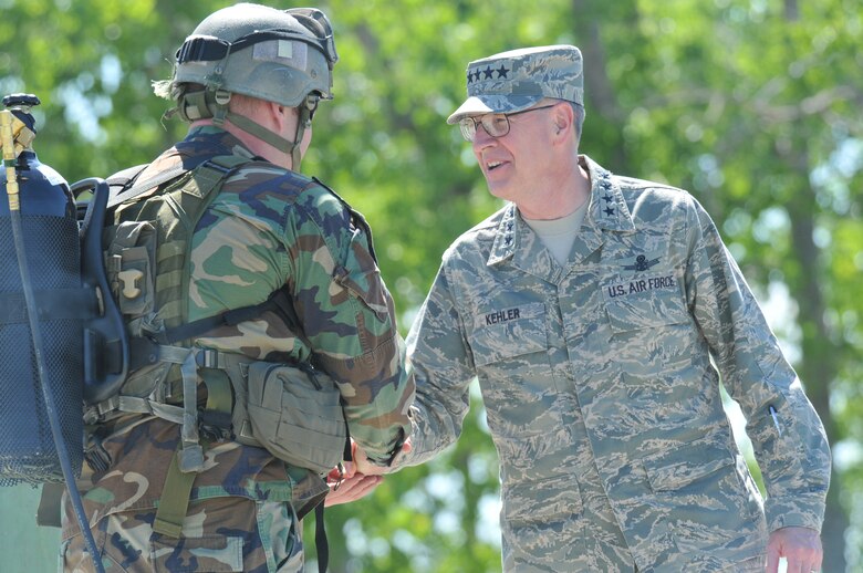 Gen. C. Robert Kehler, Air Force Space Command commander, shakes hands with Tech. Sgt. Clayton Thomas, training NCO for the 341st Security Forces Group Tactical Response Force, following a demonstration the team put on for the commander June 16. After the general had a chance to witness some Airmen in action, he addressed Team Malmstrom at an all-call. (U.S. Air Force photo/John Turner)