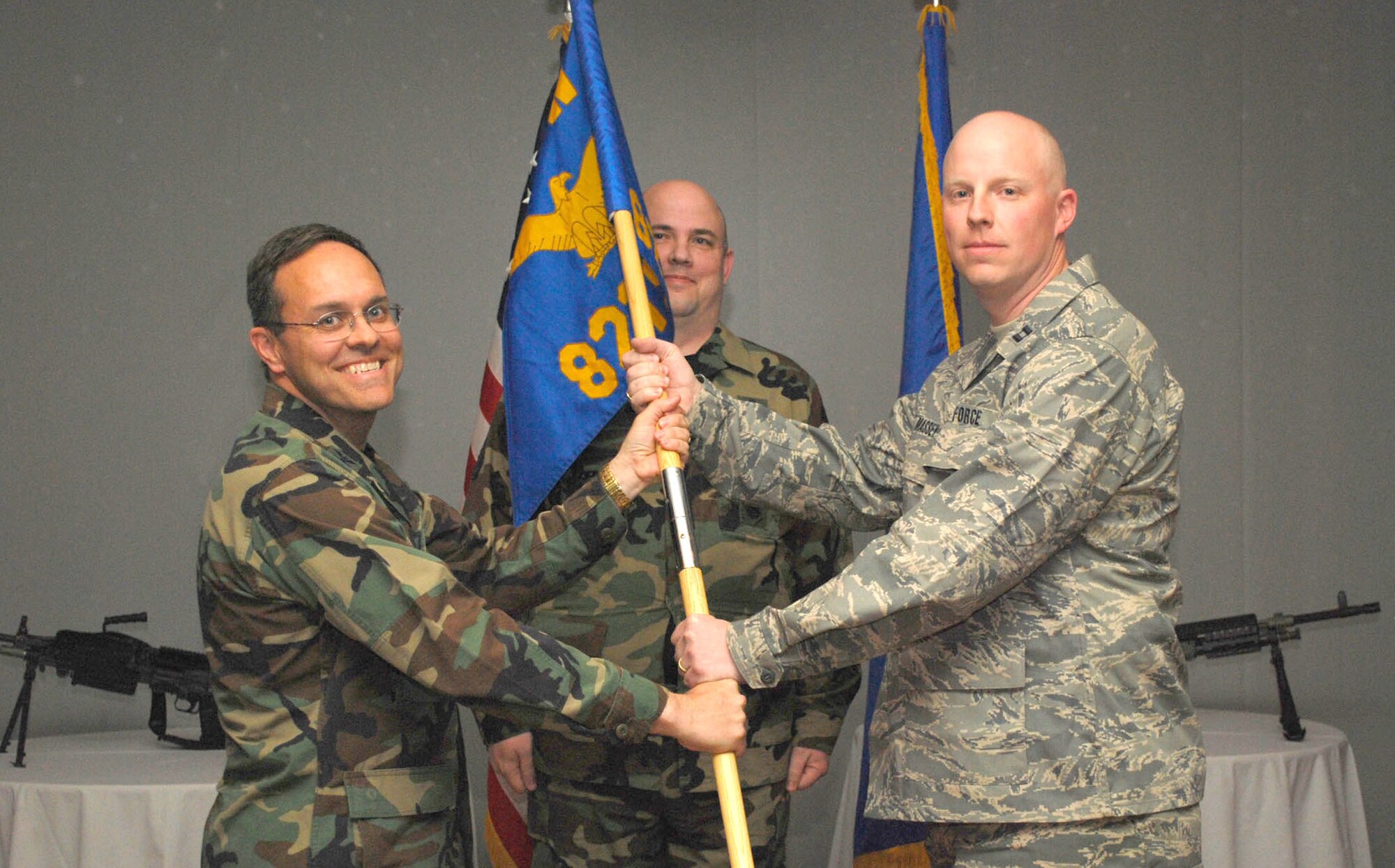 Capt. Daniel Massey receives the 821st Security Forces Squadron guidon from Col. Lee-Volker Cox, 821st Air Base Group commander, as he assumes command during the squadron’s change-of-command ceremony June 12 at the Top of the World Club at Thule Air Base, Greenland. As security forces commander for the air base, Captain Massey is responsible for law enforcement and security of the 254 square-mile Thule Defense Area. (U.S. Air Force photo/1st Lt. Nicole Langley)