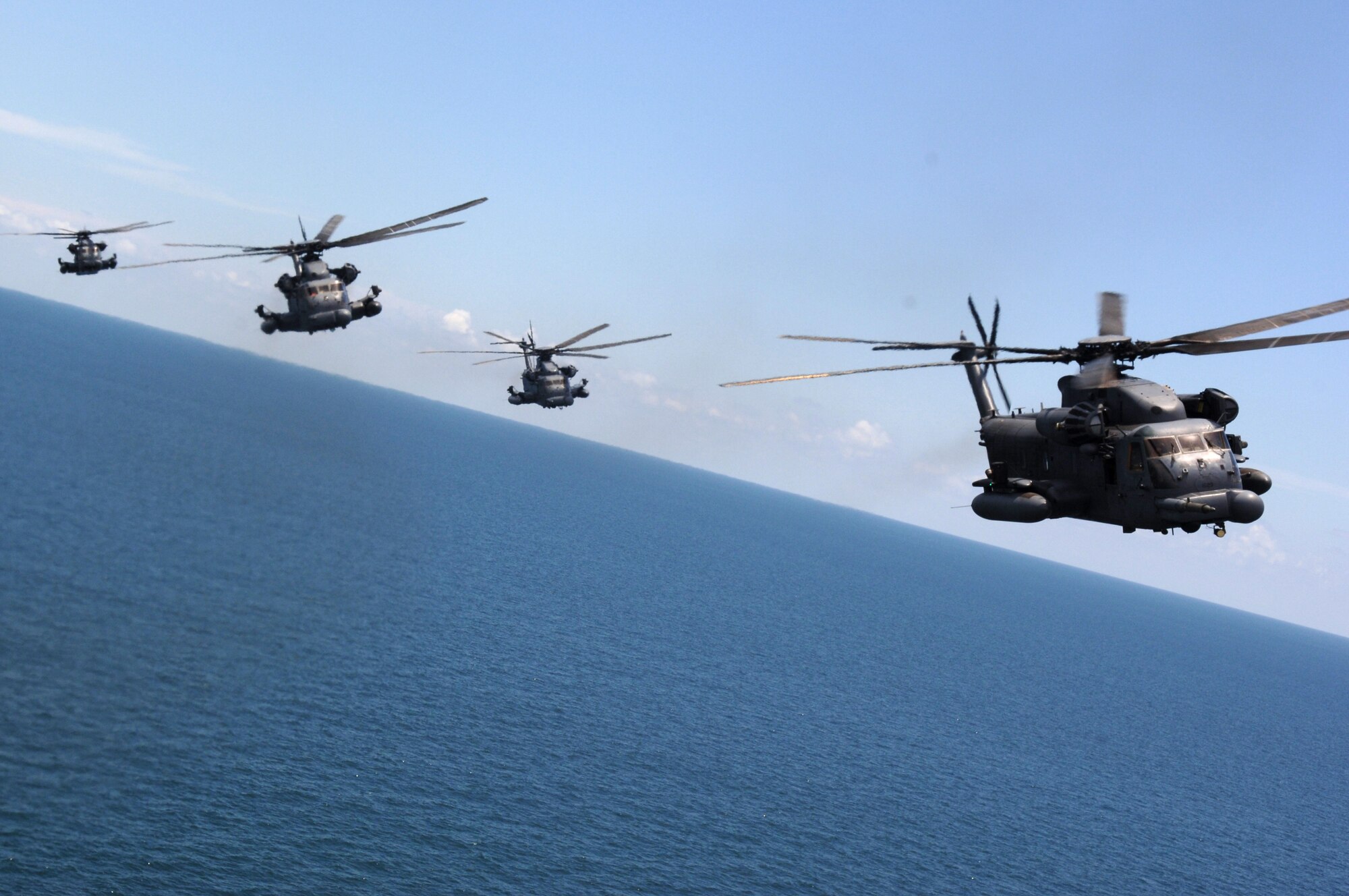 MH-53 PAVE LOW helicopters from Hurlburt Field fly over the Gulf of Mexico during the last five-ship formation of the 20th Special Operations Squadron June 12. The MH-53 will be retired from the Air Force inventory later this year. (U.S. Air Force photo/Senior Airman Emily Moore) 