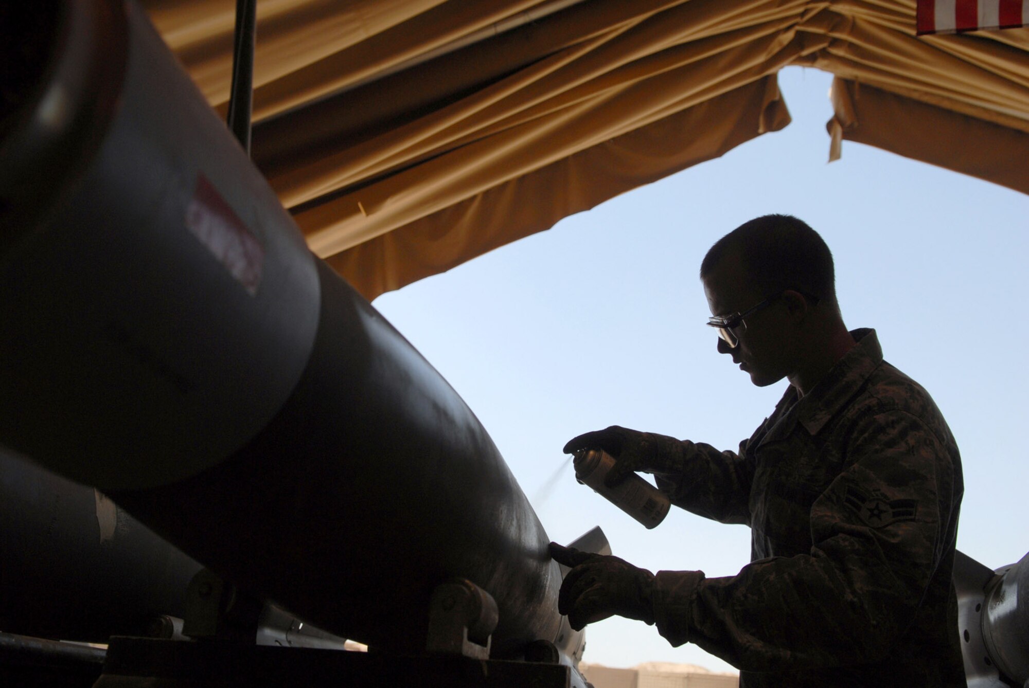 Airman 1st Class Richard Spurgeon spray paints munition specifications on a guided bomb unit-12 June 16 at Joint Base Balad, Iraq. The pained code will tell weapons loaders the munition type and what components are contained in it. The GBU-12 can self-guide to a target pinpointed by a laser designator, which helps to minimize collateral damage resulting from detonation. Airman Spurgeon is a 332nd Expeditionary Maintenance Squadron munitions systems specialist deployed from Shaw Air Force Base, S.C. (U.S. Air Force photo/Senior Airman Julianne Showalter) 