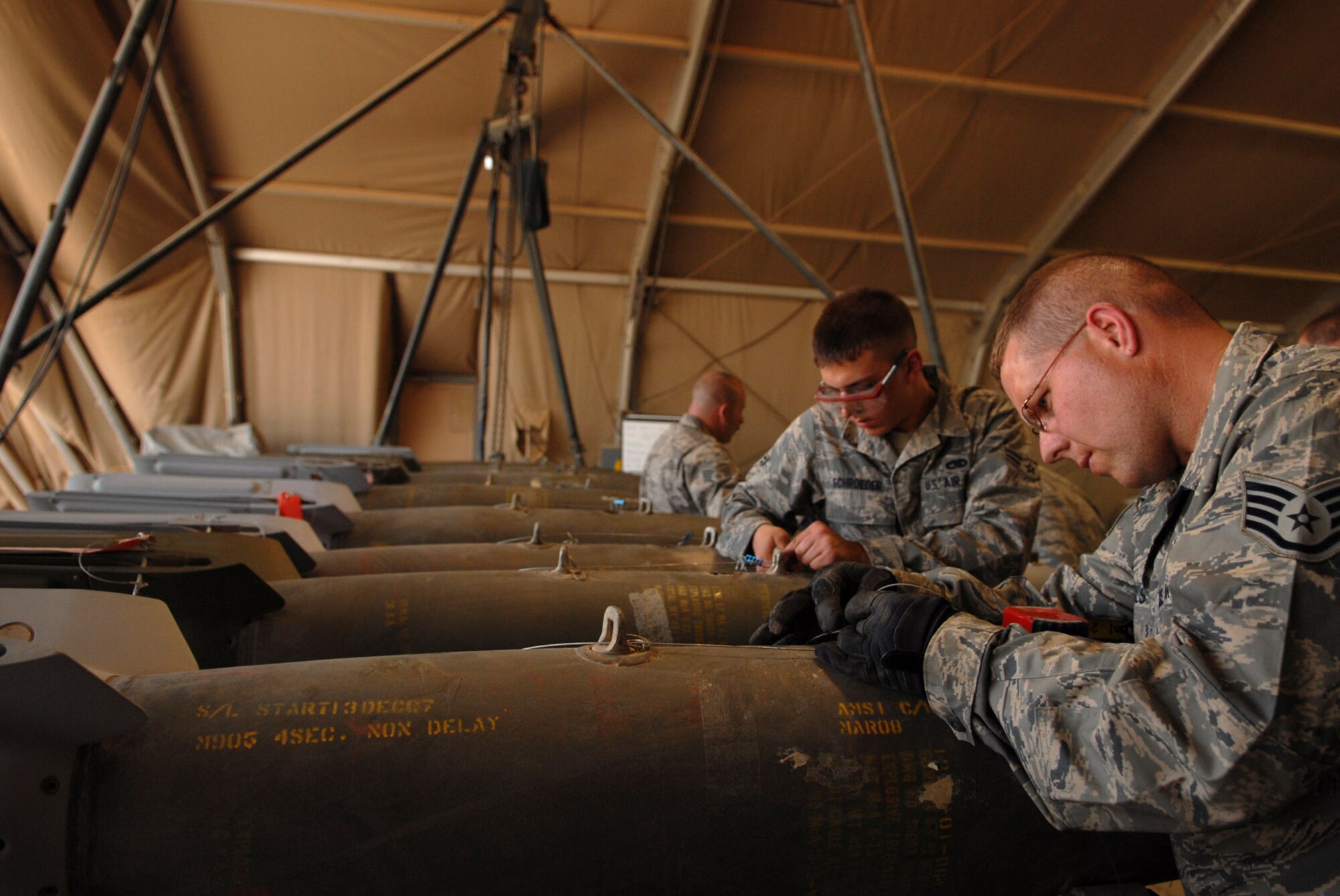 Staff Sgt. Russell Michels connects a guided bomb unit-12 arming lanyard to a bomb body June 16 at Joint Base Balad, Iraq. This lanyard, which is connected directly into the aircraft, will initiate internal components and detonation timing according to the aircraft specifications. The GBU-12 is a laser-guided munition. Sergeant Michels is a 332nd Expeditionary Maintenance Squadron munitions systems specialist deployed from Hancock Field Air National Guard Base, Syracuse, NY. (U.S. Air Force photo/Senior Airman Julianne Showalter) 