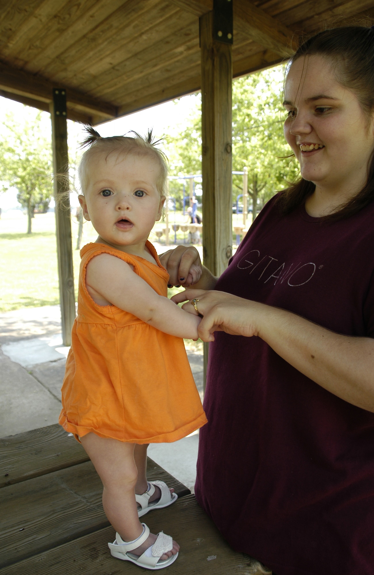 Casey Ketchel, wife of Airman 1st Class Richard Ketchel, 436th Maintenance Squadron, holds 6-month-old daughter Brianna, as she dances to the music at the Wing Picnic. (U.S. Air Force photo/Airman 1st Class Shen-Chia Chu)