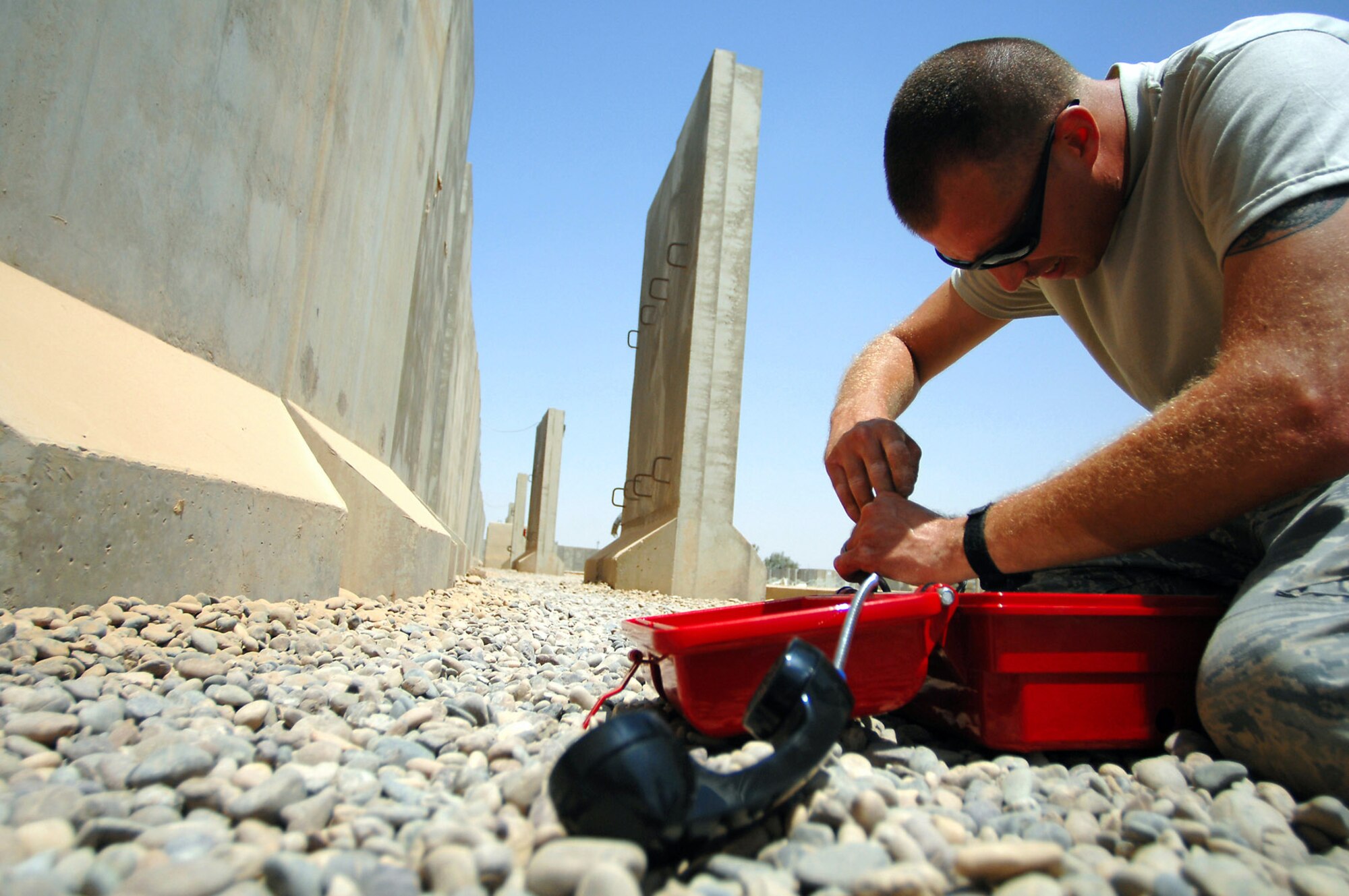 Staff Sgt. Phillip Balson installs an emergency phone June 13 at Balad Air Base, Iraq. The phones are used to establish personnel accountability during emergency situations. The infrastructure shop is installing a total of 124 lines throughout the Air Force housing area. Sergeant Balson is a 332nd Expeditionary Communications Squadron infrastructure technician deployed from Tinker Air Force Base, Okla. (U.S. Air Force photo/Senior Airman Julianne Showalter) 
