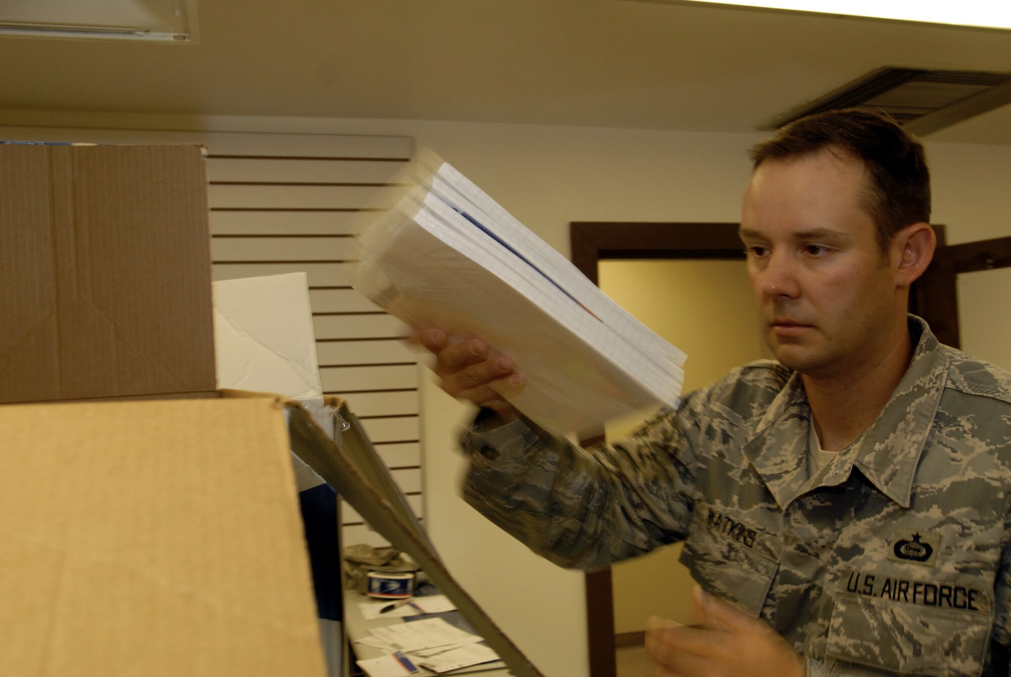 Technical Sergeant Danny Watkins rearranges a box of school supplies to Iraqi schools. (U.S. Air Force photo by Master Sgt. Randy Mallard)