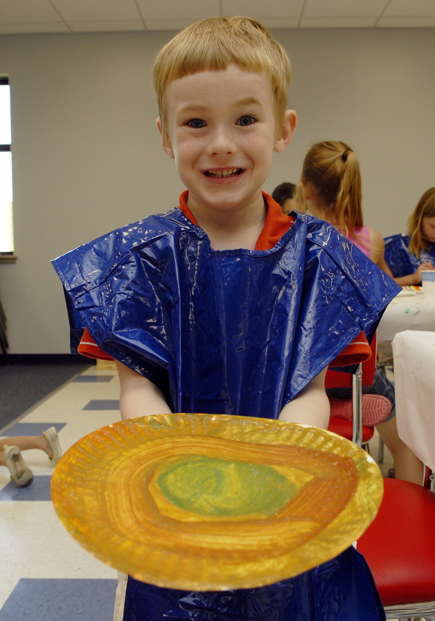 Five-year-old Logan Sullivan shows off his artistic talents during arts and crafts time at the school-age facility. Each classroom has different activities going on throughout the day to keep the children’s minds constantly stimulated, ensuring a very educational environment. (U.S. Air Force photo by Senior Airman Kamaile Chan)