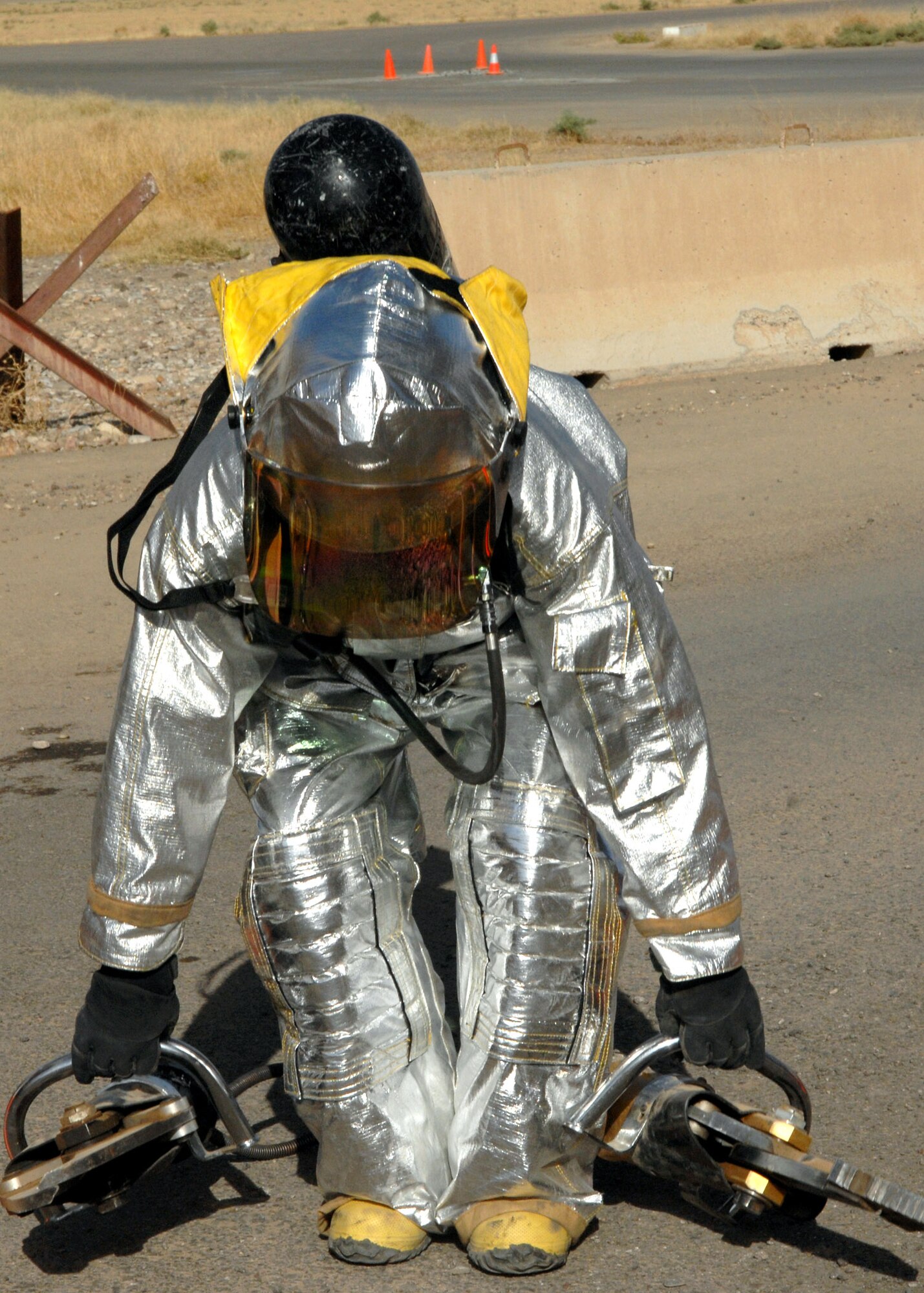 KIRKUK REGIONAL AIR BASE, Iraq – An Airman from the 506th Expeditionary Civil Engineer Squadron Fire and Emergency Services Flight participates in a training event June 16 here. The event tested the flight's ability to respond to an emergency situation in the deployed setting. (U.S. Air Force photo by Senior Airman SerMae Lampkin) 