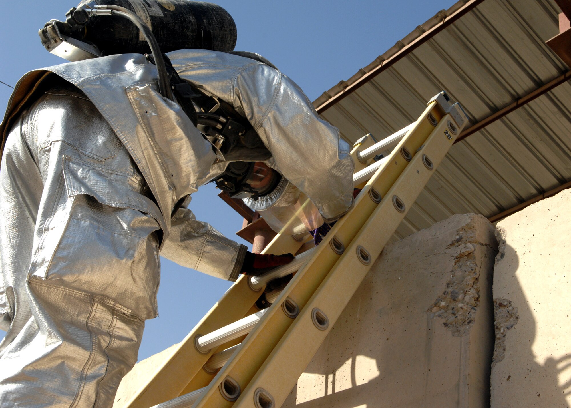 KIRKUK REGIONAL AIR BASE, Iraq – An Airmen from the 506th Expeditionary Civil Engineer Squadron Fire and Emergency Services Flight climbs a ladder during a training event June 16 here. The event tested the flight's ability to respond to an emergency situation in the deployed setting. (U.S. Air Force photo by Senior Airman SerMae Lampkin) 