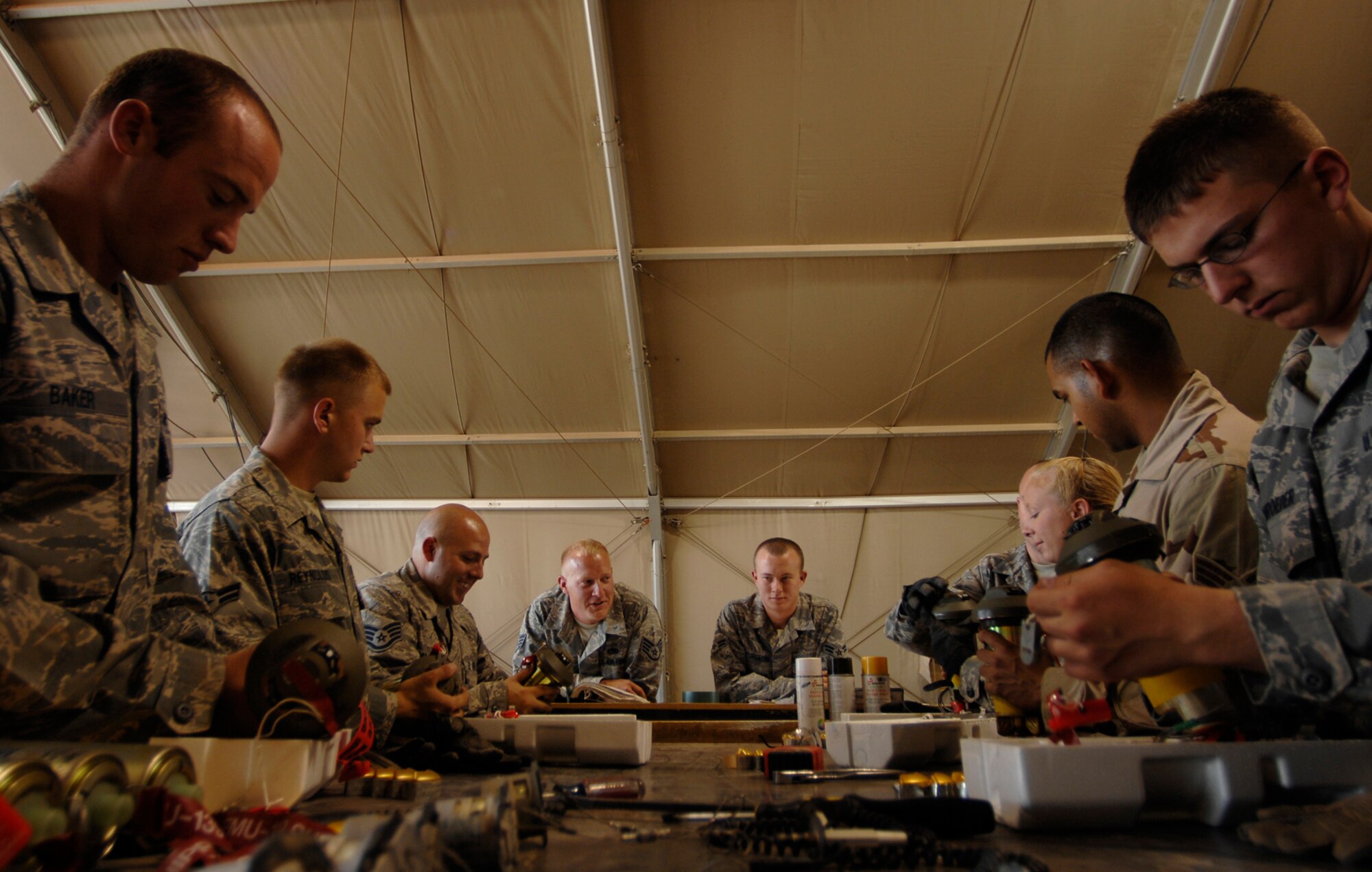 JOINT BASE BALAD, Iraq -- Munitions systems specialist Airmen assigned to the 332nd Expeditionary Maintenance Squadron, build fuses for GBU-12s here, June 16. The team is responsible for building, maintaining and storing various munitions to support Operation Iraqi Freedom kinetic strikes. The GBU-12 can self-guide to a target pinpointed by a laser designator. Since January, F-16s flown by the 332nd Expeditionary Operations Group have engaged in more than 315 kinetic strikes. (U.S. Air Force photo/ Senior Airman Julianne Showalter)