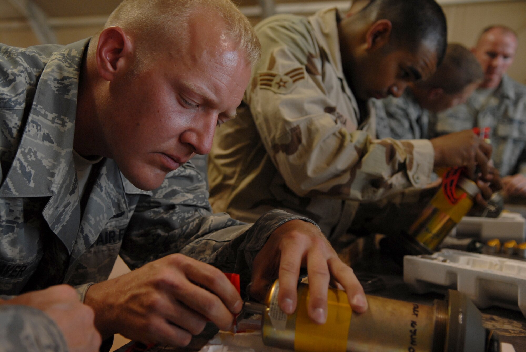 JOINT BASE BALAD, Iraq -- Staff Sgt. Dan Weaver, 332nd Expeditionary Maintenance Squadron munitions systems specialist, pieces together a fuse for a GBU-12 here, June 16. The fuse and its components detonate the munition and increase the force of the explosion; the GBU-12 can self-guide to a target pinpointed by a laser designator, which helps to minimize collateral damage resulting from detonation. Sergeant Weaver is deployed from Dover Air Force Base, Del. (U.S. Air Force photo/ Senior Airman Julianne Showalter)