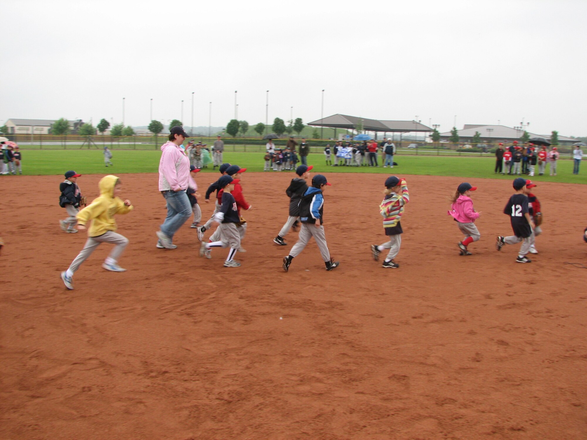 Kids race across the infield to take their positions for the opening day of youth baseball at RAF Lakenheath, England June 8. The games will continue until mid-July. (U.S. Air Force photo by Senior Master Sgt. Thomas Wood)