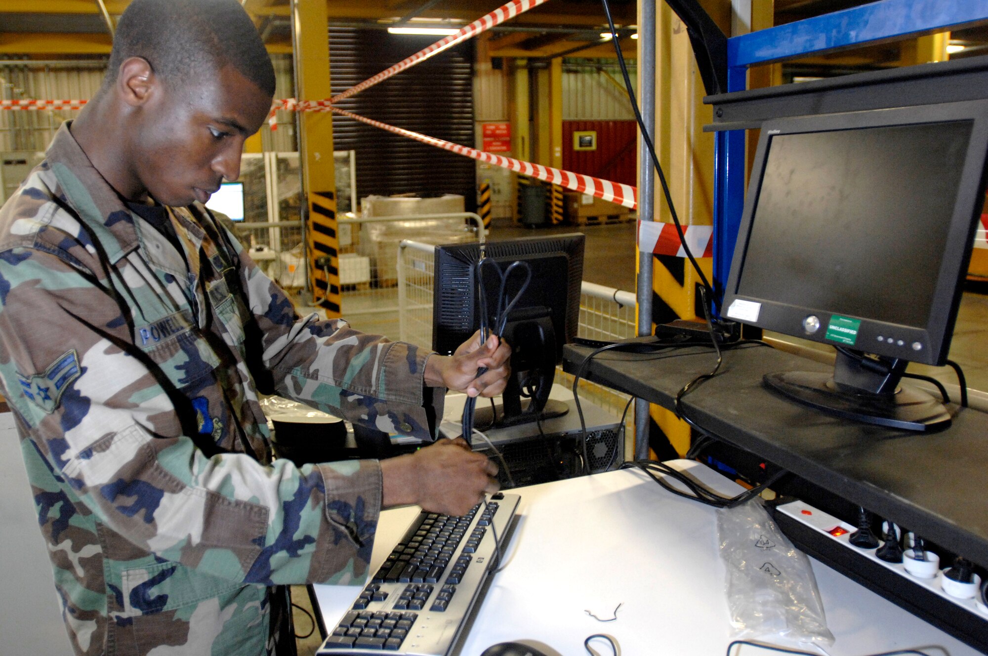 AVIANO AIR BASE, Italy --  Airman 1st Class Christopher Powell, Client Support Team connects computers to a new testing cell relocated in a building closer to them.  With the help of AFSO 21, CST's can get their job done faster by having the new ADPE cell located on base.  (U.S. Air Force photo/Airman 1st Class Ashley Wood)