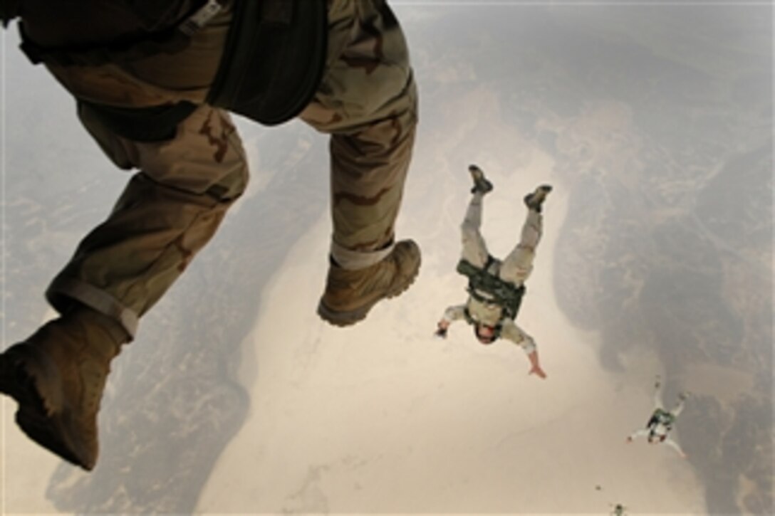U.S. Air Force pararescuemen leap from a CH-53 Sea Stallion helicopter during a training mission over Djibouti on June 9, 2008.  The pararescuemen are from the 82nd Expeditionary Rescue Squadron out of Davis-Monthan Air Force Base, Ariz.  