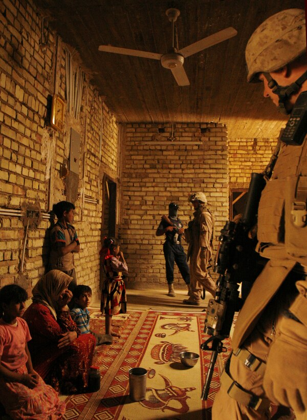 FALLUJAH, Iraq â?? Company K, 3rd Battalion, 6th Marines assist Iraqi Police in searching a house in a rural area of Fallujah, June 17. The company recently detached from a Joint Service Station in the Khadairy district to make way for the transition of security to Iraqi Police. Coalition Forces continue to provide an overwatch role for Iraqi missions. (Official U.S. Marine Corps photo by Cpl. Chris Lyttle) (RELEASED)