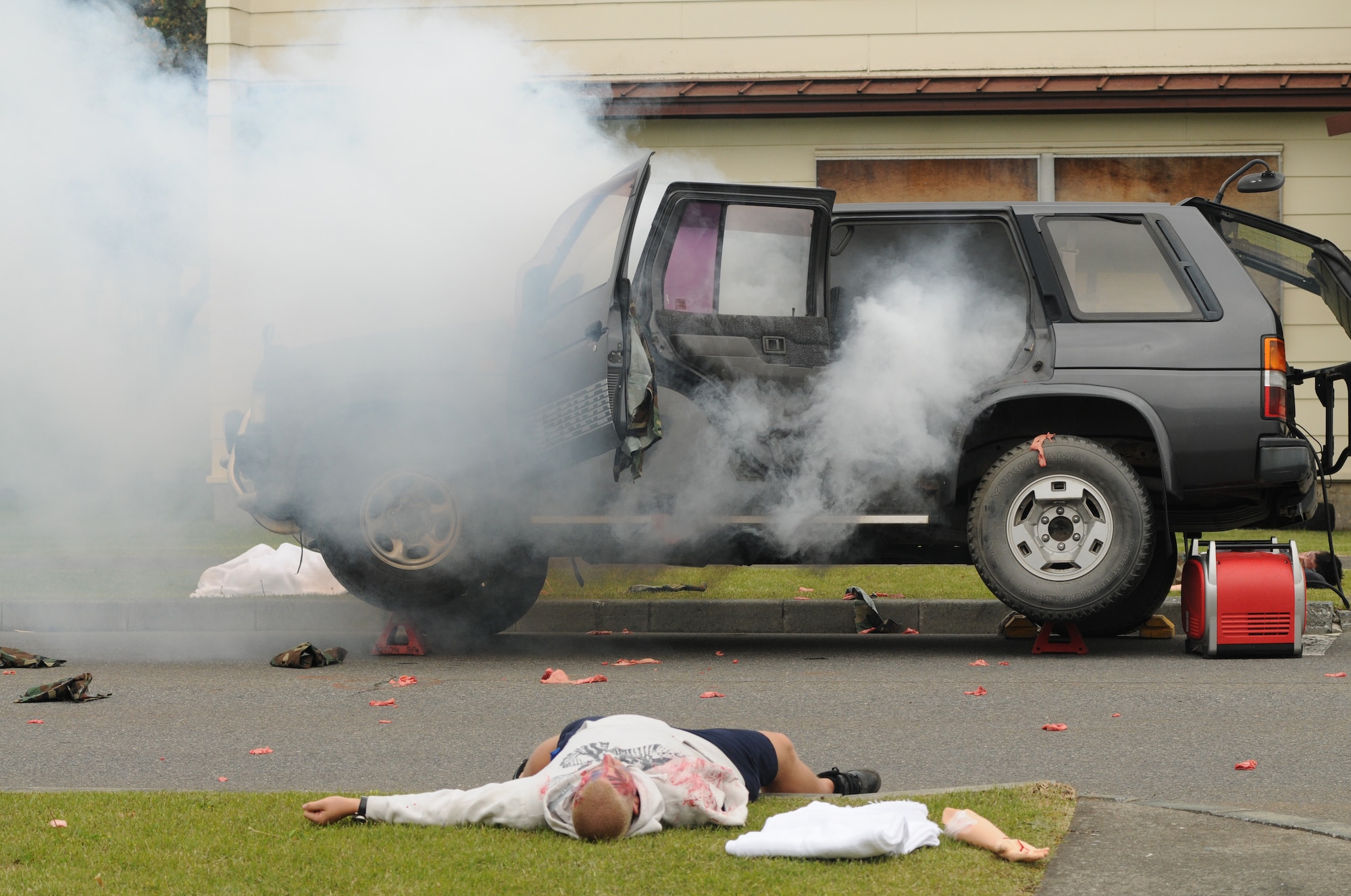 MISAWA AIR BASE, Japan -- A simulated car bomb explodes inside an SUV leaving simulated casualties and debris in base housing May 28. The exercise tested the 35th Fighter Wing’s capability for real-world responders to react in times of crisis. Fake props and actors are used in order to create the most realistic environment possible. (U.S. Air Force photo by Staff Sgt. Samuel Morse)