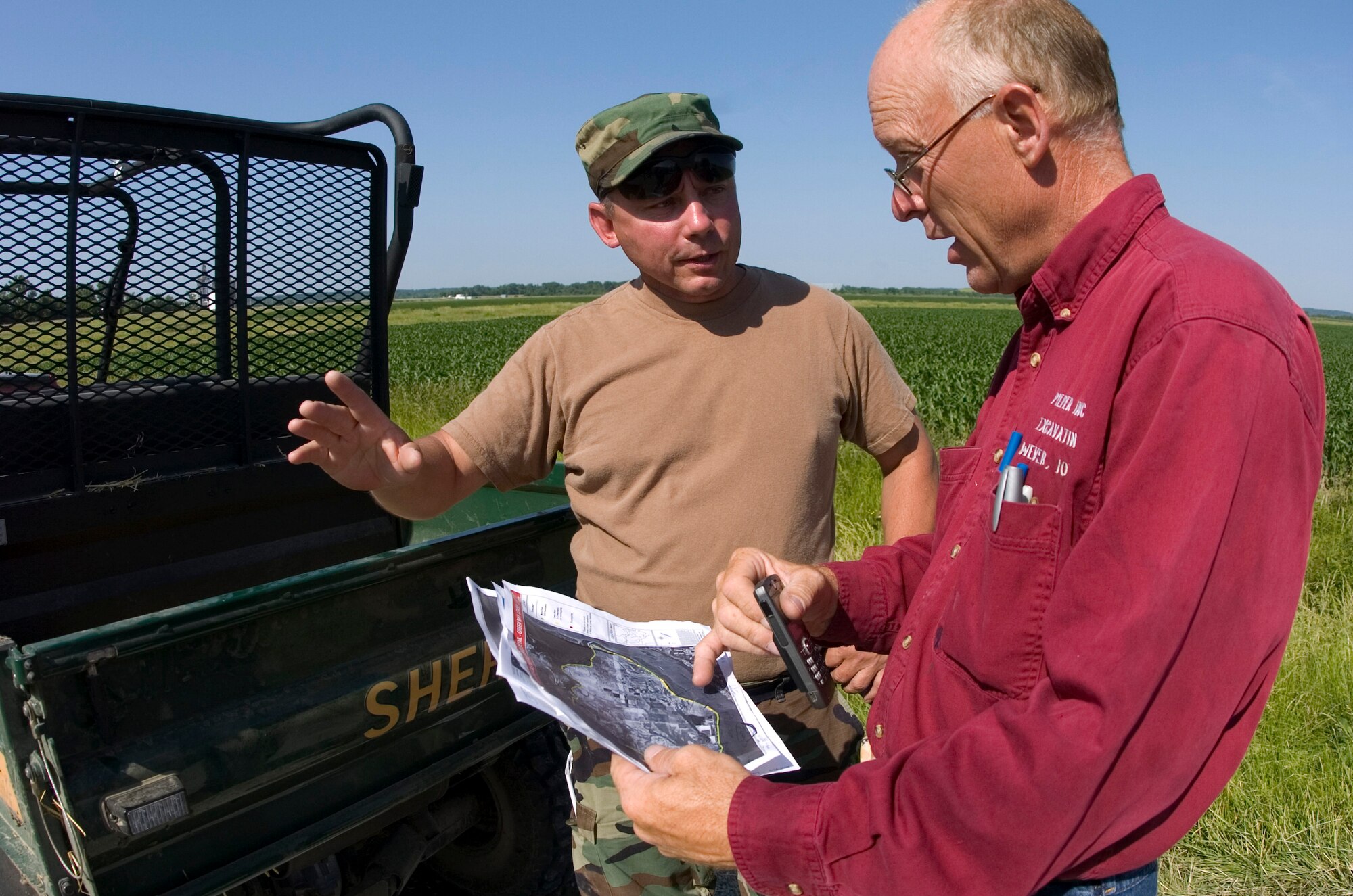 Senior Master Sgt. William Davline speaks with Mike Pieper, the Green Bay Bottom Levee and Draining District chairman, June 18. The town of Green Bay Bottom, Iowa, is in critical condition because it iss where the Skunk River meets the Mississippi River. Approximately 14,000 acres of farmland is in danger of erosion if the flooding is not controlled. Sergeant Davline is Air National Guardsman assigned to the 185th Air Refueling Wing located in Sioux City, Iowa. (U.S. Air Force photo/Staff Sgt. Desiree N. Palacios) 