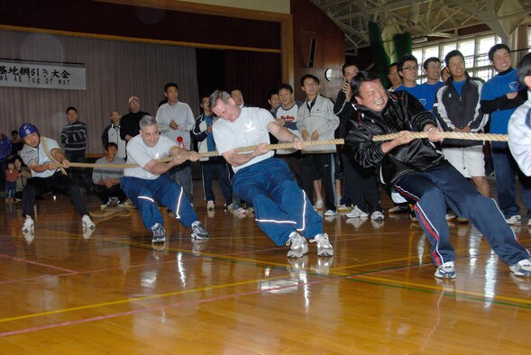 MISAWA AIR BASE, Japan -- Chief Master Sgt. Ricky Price, 35th Fighter Wing command chief, and Col. T.J. O'Shaughnessy, 35th Fighter Wing commander, team up with VIPs and Japan Air Self Defense Force Senior NCOs during the 7th annual tug-of-war competition on June 14, 2008.  The Northern Air Defense Force/ Commanders Cup Tug-of-War competition is held annually to support and strengthen U.S. and Japanese relations.  (U.S. Air Force photo by Senior Airman Laura R. McFarlane)