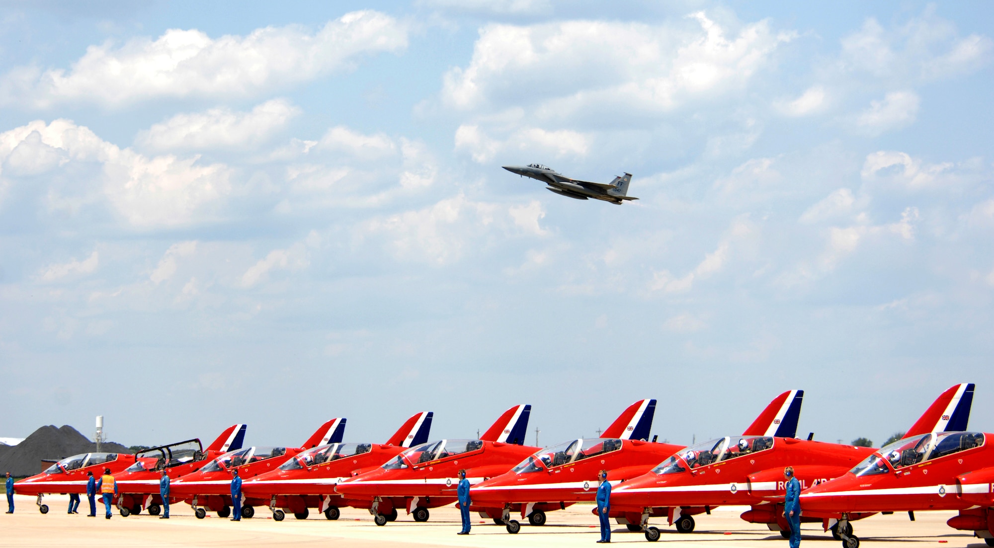 LANGLEY AIR FORCE BASE, Va. -- An F-15 Eagle flies above the British Royal Air Force Aerobatic Team, The Red Arrows, here June 18. The Red Arrows will perform during AirPower over Hampton Roads, Langley’s air show, which is scheduled for June 20 to 22. (U.S. Air Force photo/Airman 1st Class Aaron Johnson)