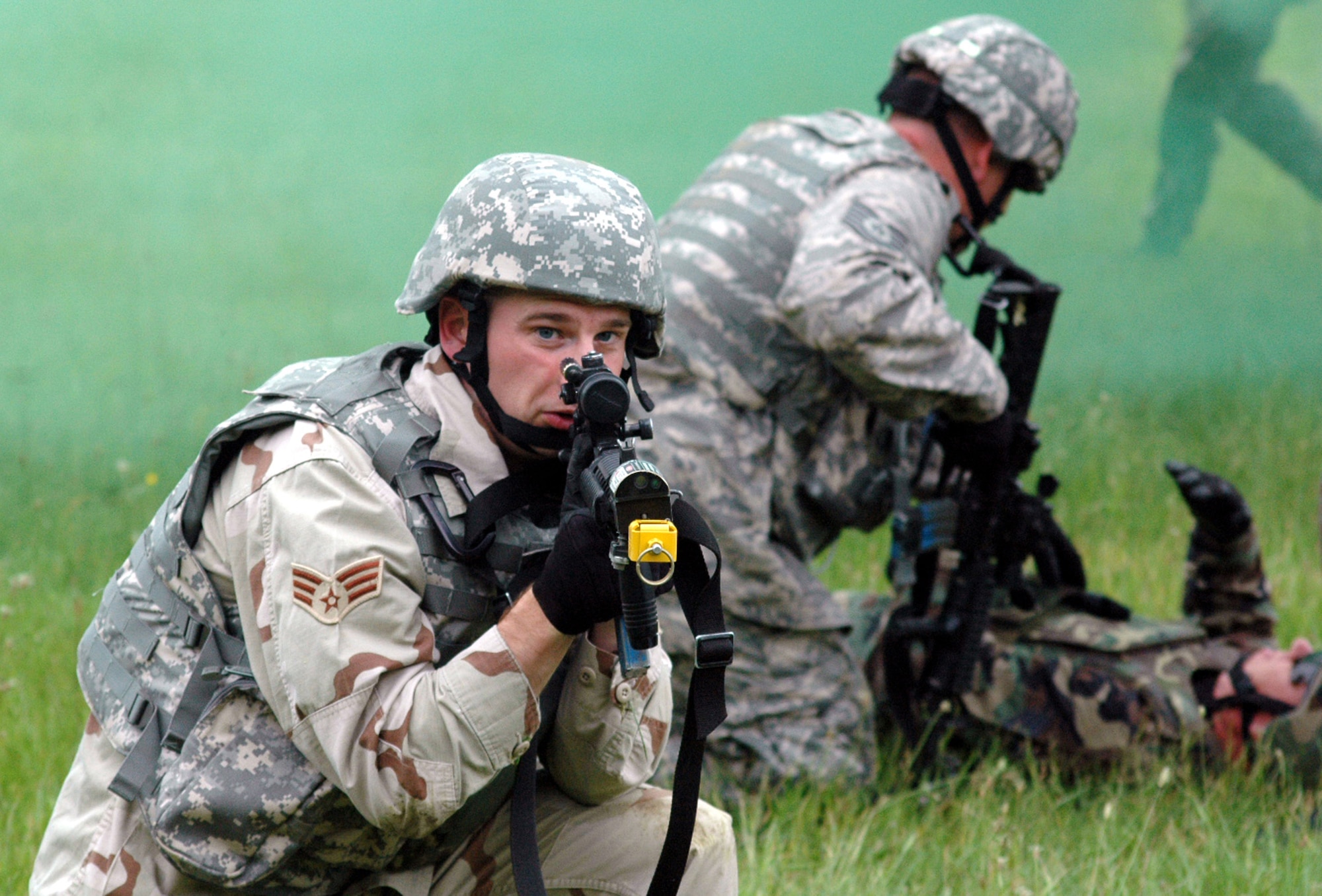 A student in the Air Force Phoenix Warrior Training Course provides security while another looks after a victim during training in a combat first aid class June 5 at Fort Dix, N.J. The course is taught by members of the Air Force Expeditionary Center's Expeditionary Operations School and 421st Combat Training Squadron and prepares  Airmen for upcoming deployments. Annually, the course trains more than 23,000 students in expeditionary- and mobility air force-based courses both with in-residence and distance learning. (U.S. Air Force photo/Tech. Sgt. Scott T. Sturkol) 