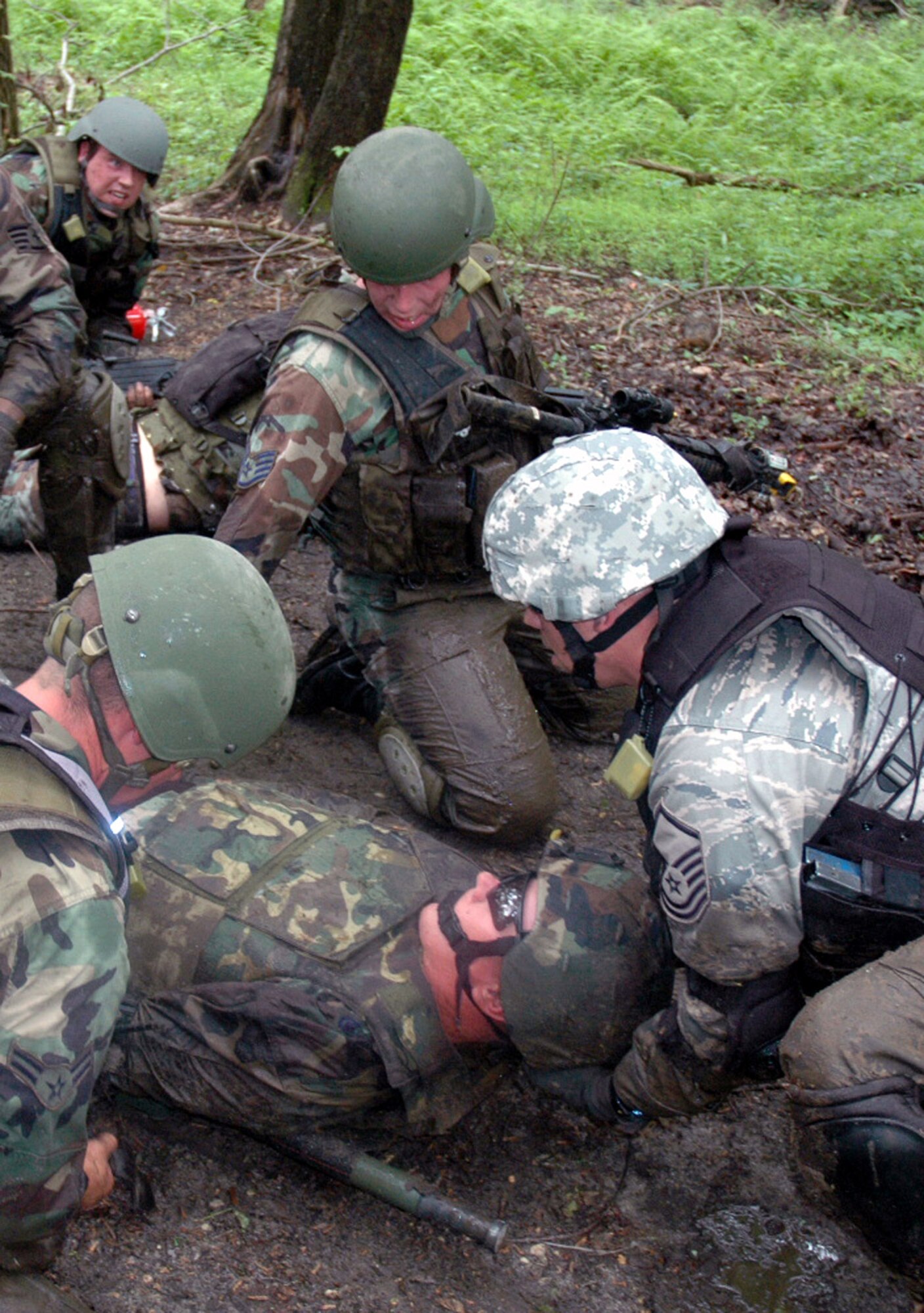 Students in the Air Force Phoenix Warrior Training Course tend to a victim during training in a combat first aid class June 5 at Fort Dix, N.J. The course is taught by members of Air Force Expeditionary Center's Expeditionary Operations School and 421st Combat Training Squadron and prepares Airmen for upcoming deployments. Annually, the course trains more than 23,000 students in expeditionary and mobility air force-based courses both with in-residence and distance learning. (U.S. Air Force Photo/Tech. Sgt. Scott T. Sturkol) 