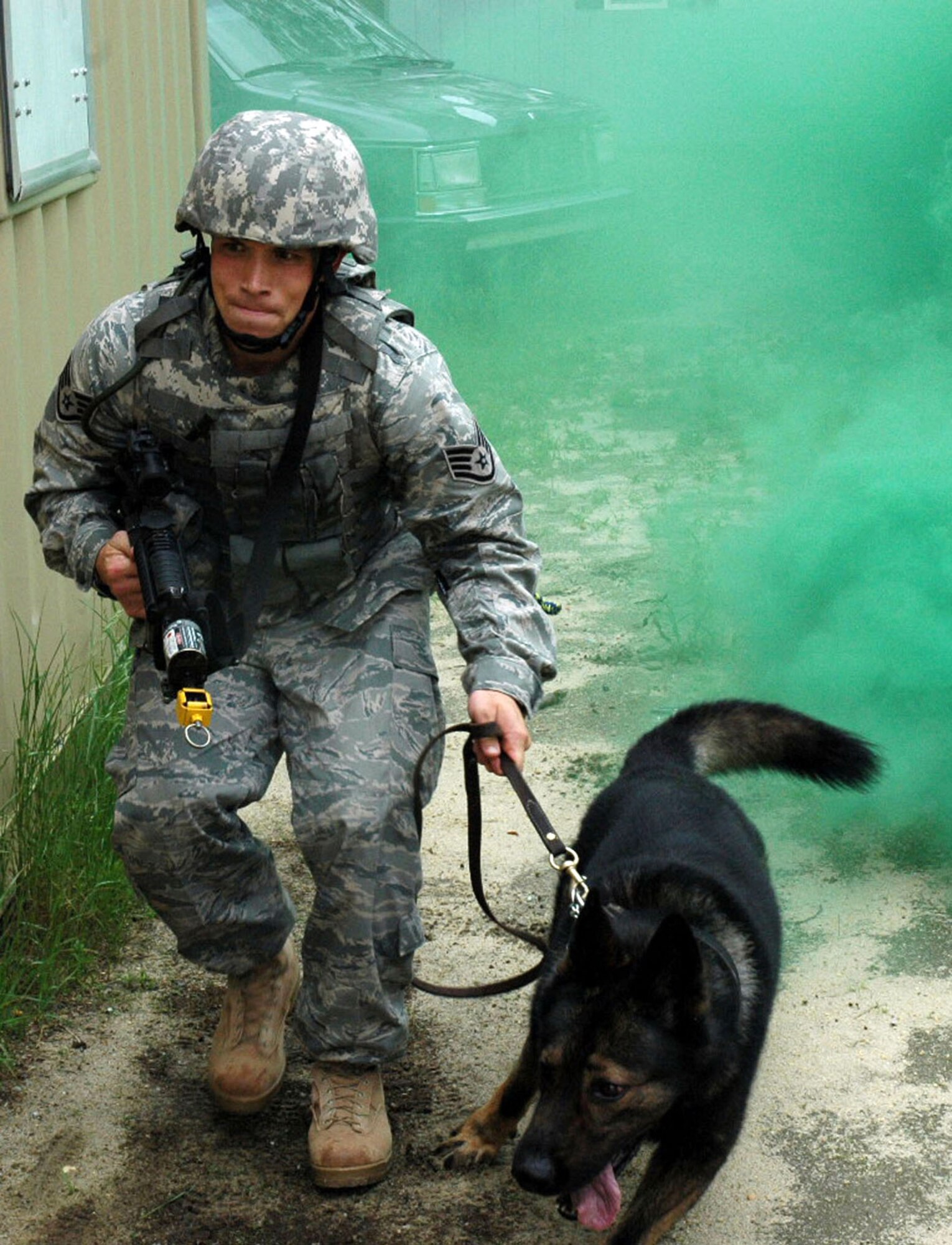 Staff Sgt. Clifford Hartley and his military working dog, Cir participate in canine military operations in urban terrain training June 5. at Naval Air Engineering Station Lakehurst, N.J. Their training was part of the Air Force Phoenix Warrior Course which trains security forces for upcoming deployments. The course is operated by members of Air Force Expeditionary Center at Fort Dix, N.J.  Sergeant Hartley and Cir are from the 437th Security Forces Squadron, Charleston Air Force Base, S.C.(U.S. Air Force Photo/Staff Sgt. Paul Evans) 
