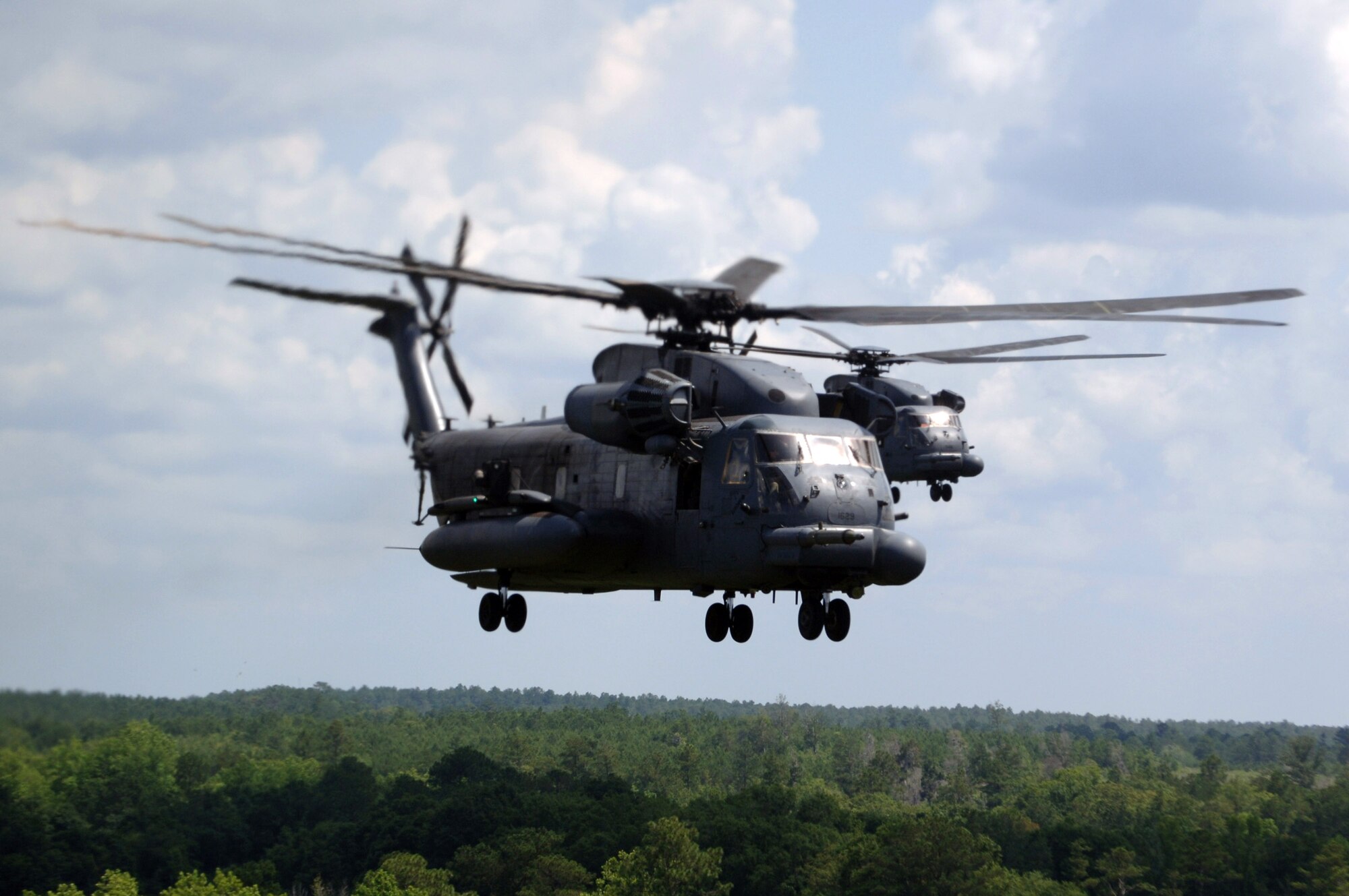 MH-53 Pave Low helicopters from the 20th Special Operations Squadron at Hurlburt Field, Fla., fly over a live-fire range June 12 at Eglin Air Force Base, Fla. The Pave Low's mission is low-level, long-range, undetected penetration into denied areas, day or night, in adverse weather, for infiltration, exfiltration and resupply of special operations forces. (U.S. Air Force photo/Senior Airman Emily Moore) 