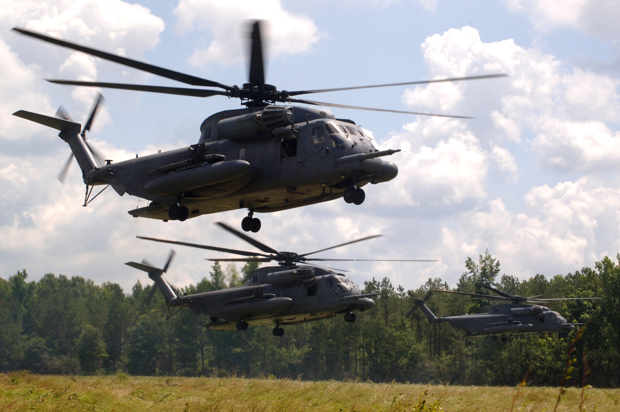 MH-53 Pave Low helicopters from the 20th Special Operations Squadron at Hurlburt Field, Fla., fly over a live-fire range June 12 at Eglin Air Force Base, Fla. The helicopter's terrain-following and terrain-avoidance radar, forward-looking infrared sensor, inertial navigation system with global positioning system enable the crew to follow terrain contours. This helps the crew to avoid obstacles in adverse weather, making low-level tactical penetration possible. (U.S. Air Force photo/Senior Airman Emily Moore) 