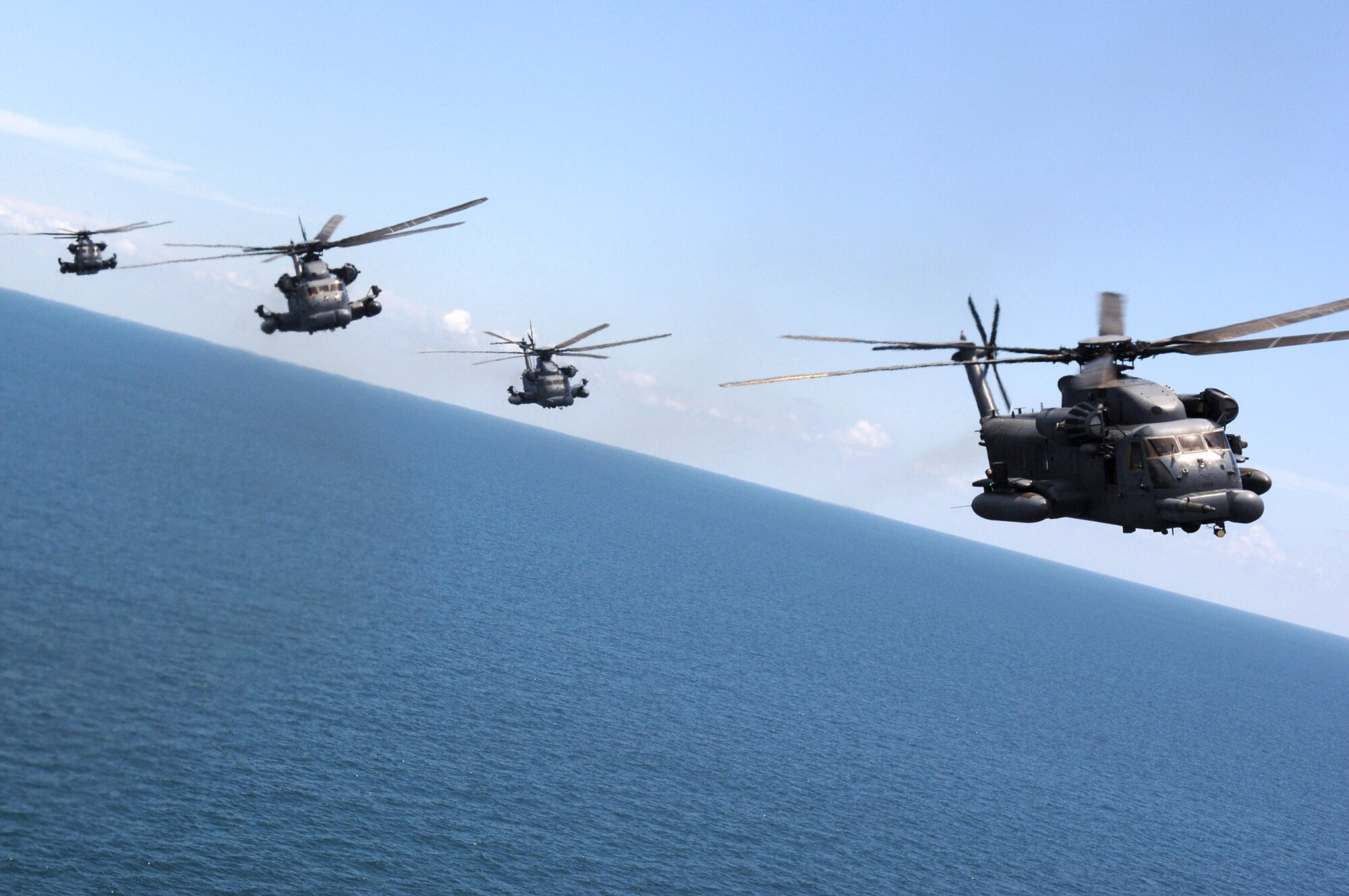MH-53 Pave Low helicopters from the 20th Special Operations Squadron at Hurlburt Field, Fla., fly over a live-fire range June 12 at Eglin Air Force Base, Fla. The projected map display enables the crew to follow terrain contours helping them to avoid obstacles in adverse weather, making low-level tactical penetration possible. (U.S. Air Force photo/Senior Airman Emily Moore) 
