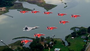 LANGLEY AIR FORCE BASE, Va. – Maj. Paul "Max" Moga, F-22A Raptor Demonstration Team pilot, flies in formation with British Royal Air Force Aerobatic Team, The Red Arrows, during an afternoon practice flight here June 18. Both demonstration teams will perform at AirPower over Hampton Roads, Langley’s air show, which is scheduled for June 20 to 22. (U.S. Air Force photo/Staff Sgt. Samuel Rogers)