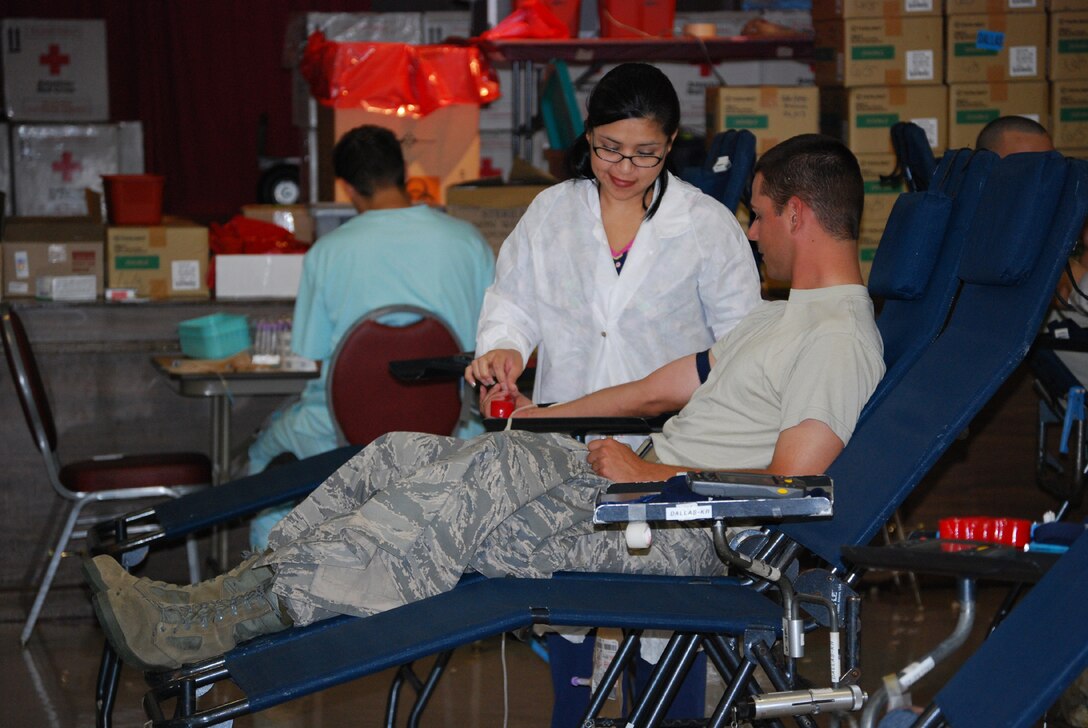 Naomi Jimenez, a phelbotomist for the American Red Cross, draws blood from Airman 1st Class Jason Jones, a student in the 361st Training Squadron, during the Red Cross Blood Drives at the community center June 17-19. (U.S. Air Force photo/Airman 1st Class Jacob Corbin)