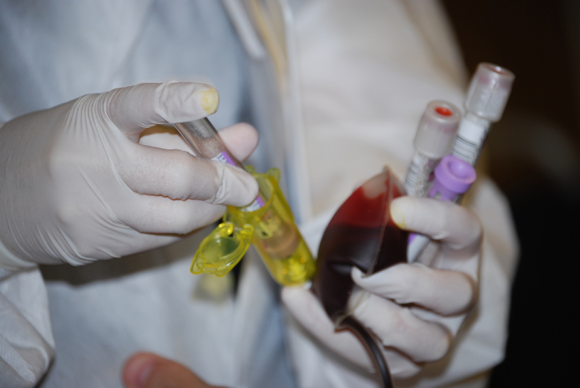 Jennifer Diaz, a phelbotomist for the American Red Cross, draws blood from Airmen during the Red Cross Blood Drives at the community center June 17-19. (U.S. Air Force photo/Airman 1st Class Jacob Corbin)