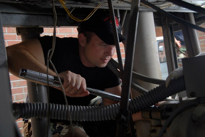 Senior Airman Nevada Grassie works on an air conditioning unit at the base chapel June 13. Heating, ventilation and air conditioning Airmen are responsible for servicing AC units for more than 265 buildings on base to ensure the comfort of Team Charleston members. Airman Grassie is assigned to the 437th Civil Engineer Squadron as a HVAC specialist. (U.S. Air Force photo/Airman 1st Class Cynthia Spalding)