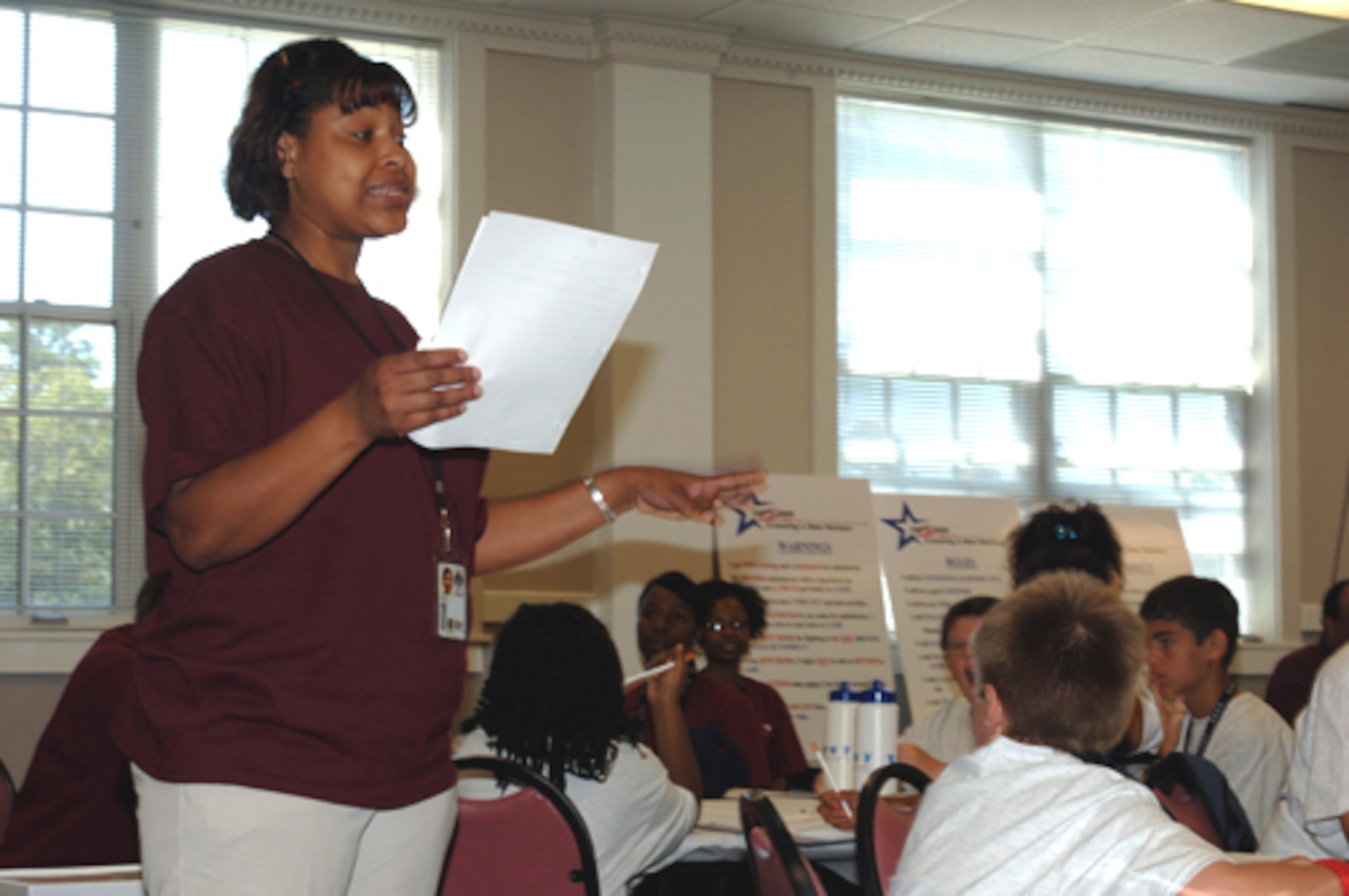 Sherri McCrary, 14th Logistics Readiness Division, gives the students at the Drug Education for Youth instructions for their next activity. The camp kicked off by giving the children an exercise to help them get to know each other and establish teams for the duration of the camp. (U.S. Air Force photo by Airman Josh Harbin)