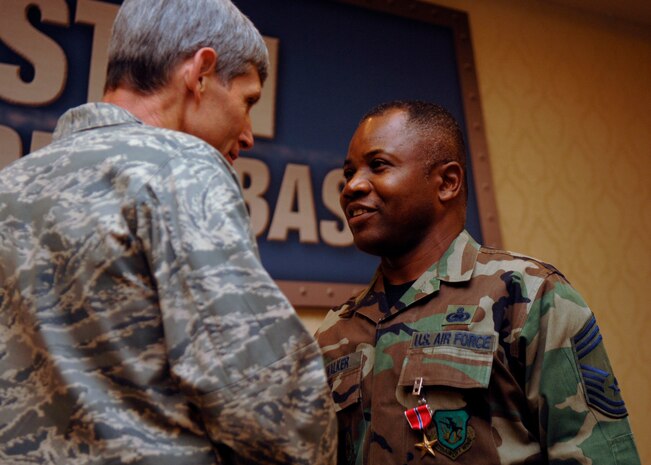 Gen. Norton Schwartz congratulates Chief Master Sgt. Stanley Walker on receiving his bronze star at the C-17 15th Anniversary celebration June 14 at the Charleston Club. General Schwartz is the commander of the U.S. Transportation Command. Chief Walker is with the 437th Logistics Readiness Squadron.(U.S. Air Force photo/Airman 1st Class Katie Gieratz)