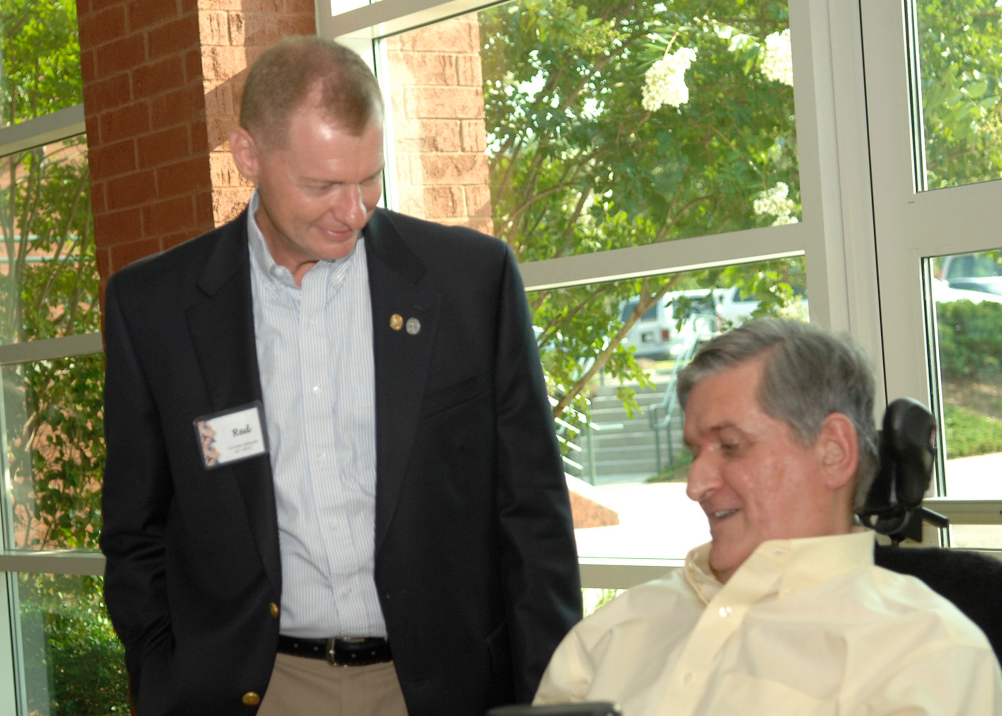 Col. John "Red" Millander speaks to retired Brig. Gen. Thomas Mikolajcik at the C-17 15th Anniversary social at the Embassy Suites in North Charleston, S.C., June 13. Colonel Millander is the 437th Airlift Wing commander. (U.S. Air Force photo/Airman 1st Class Katie Gieratz)