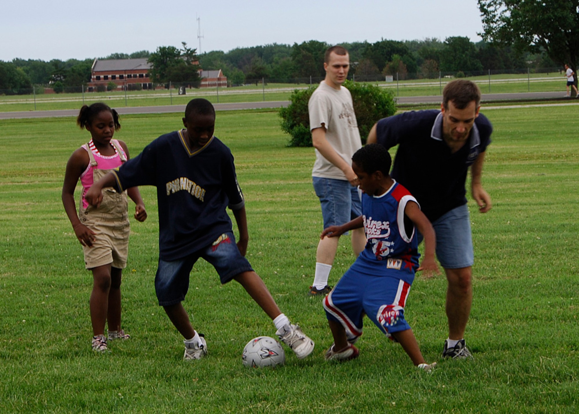 SCOTT AIR FORCE BASE, Ill. -- Kids from Big Brother Big Sisters of Southwestern Illinois enjoy a game of soccer with volunteers from Scott Air Force Base during a picnic June 13. Scott hosts an annual picnic for Big Brother Big Sister of Southwestern Illinois in which the kids can come on base and have a good time. This year the kids were treated to a lunch and games before heading off to finish their visit out at the pool.  
(U.S. Air Force photo/Airman 1st Class Wesley Farnsworth)