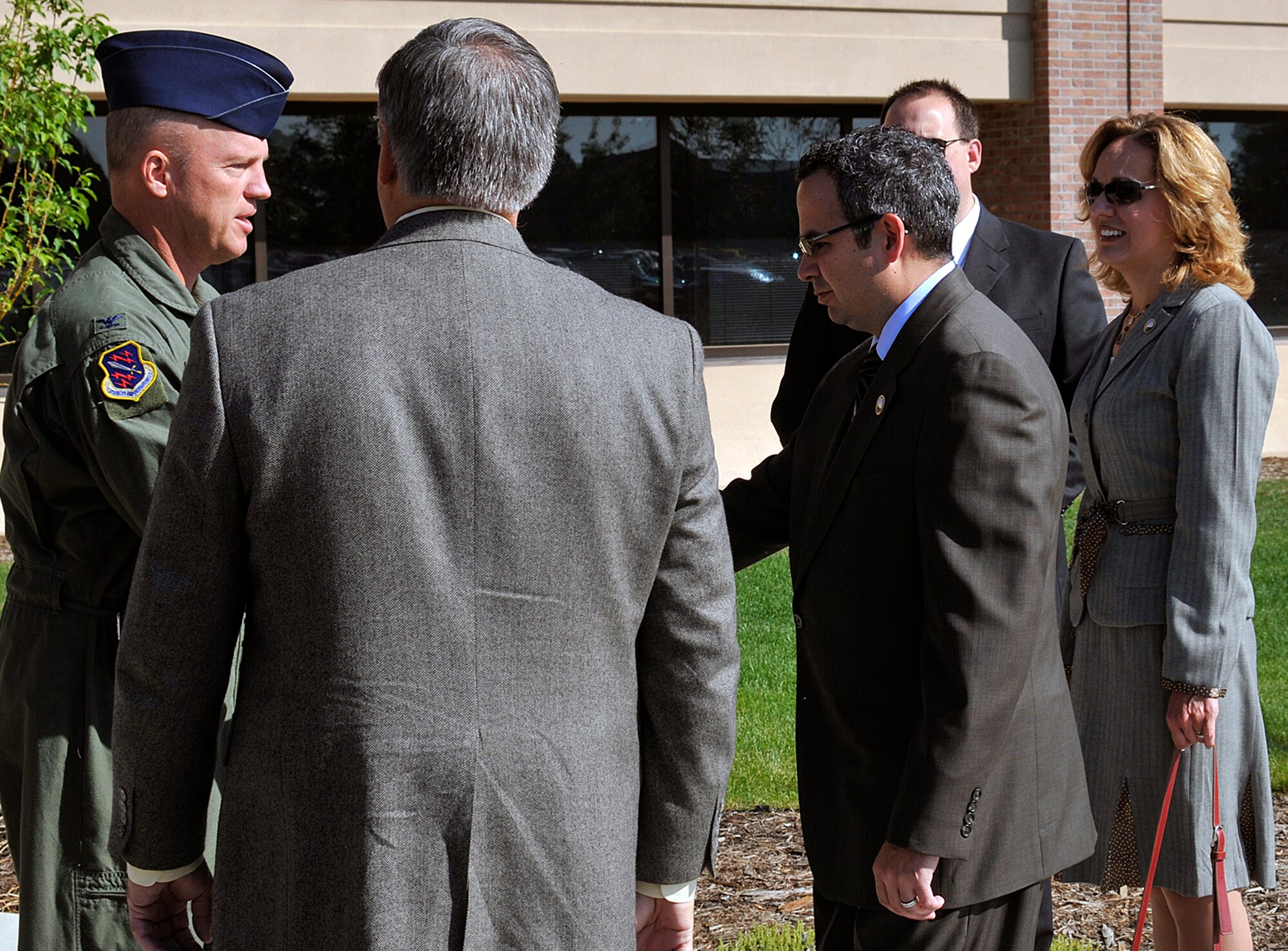 Col. Jay Raymond, 21st Space Wing commander, greets Dennis Hisey, Jeff Greene and Amy Lathen outside Building 350. Mr. Hisey and Mrs. Lathen are El Paso County commissioners, and Greene is the El Paso County administrator. The three were at the base June 17 for both a wing mission and BluePrint-2050 briefing. (U.S. Air Force photo/Larry Hulst)