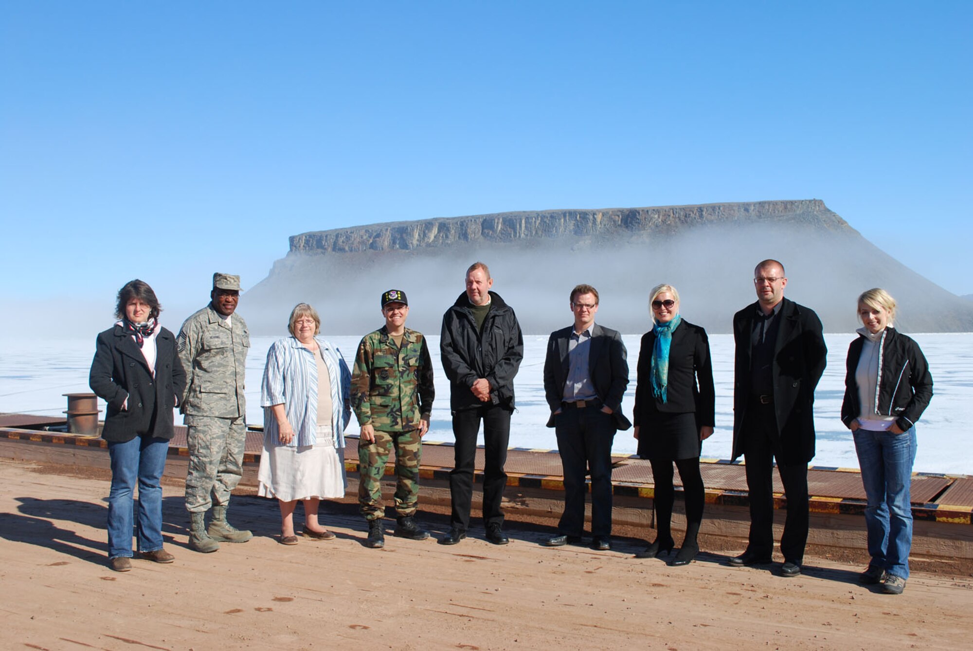 THULE AIR BASE, Greenland – A U.S. Embassy in Denmark-sponsored group poses for a photo with members of Thule Air Base during a brief visit here June 18. Pictured from left to right are: Theresa Nielsen, U.S. Embassy management assistant; Chief Master Sgt. Al Herring, 821st Air Base Group superintendent; Inge Bulck, Greenland Contractors site manager; Col. Lee-Volker Cox, 821st ABG commander; Henrik Jepsen, U.S. Embassy senior political specialist; Peter Hummelgaard Thomsen, President of Social Democratic Party Youth Organization; Anne Paulin, International Secretary for Social Democratic Party Youth; Bjarne Fog Corydon, Chief Foreign Policy Advisor for Social Democratic Party leader, Helle Thorning-Schmidt, and head of SDP Political-Economic Department; and Annika Smith, Political Assistant for Greenlandic MP (Siumut), Juliane Henningsen. (U.S. Air Force photo/1st Lt. Nicole Langley)