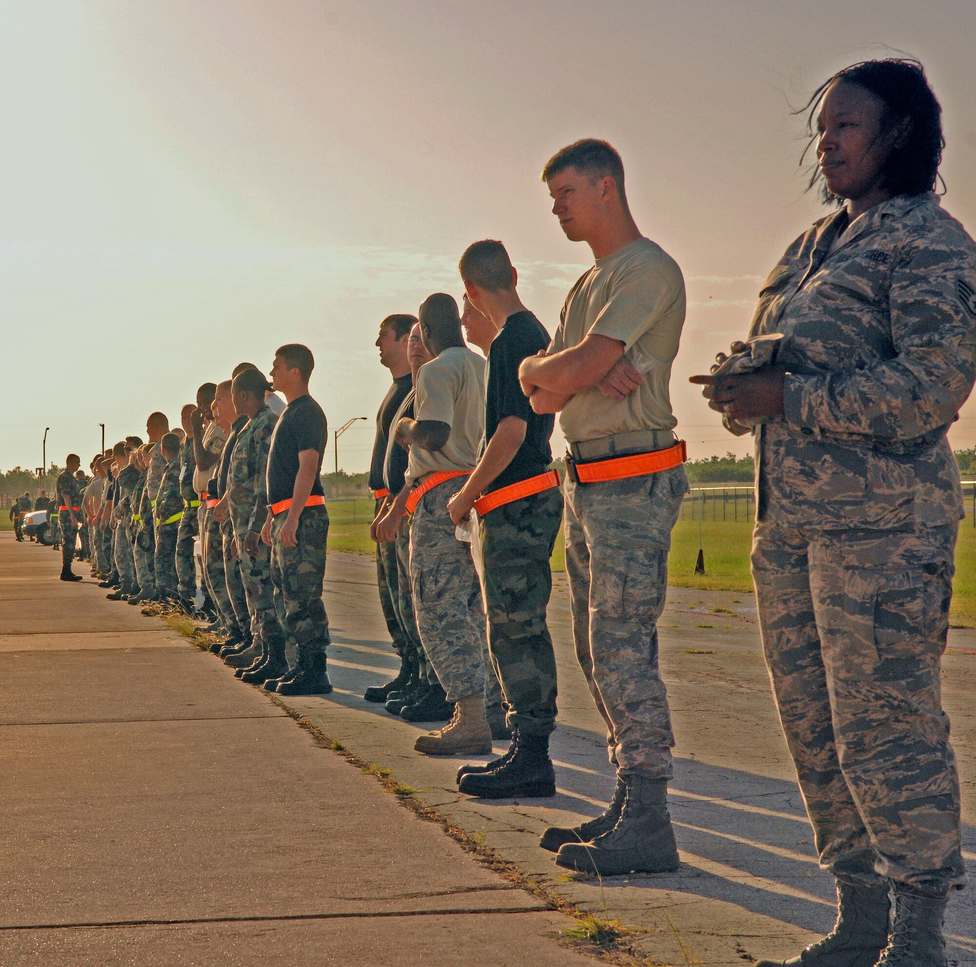 DYESS AIR FORCE BASE, Texas -- Airmen lineup for the periodic wing FOD walk, June 16. FOD is any object potentially harmful to an aircraft. It ranges from bolts, screws and metal pieces, to rocks, paper, plastic and plants. FOD can cost the Air Force millions of dollars, as a result of damages to aircraft. (U.S. Air Force photo by Staff Sergeant Connor Estes).      