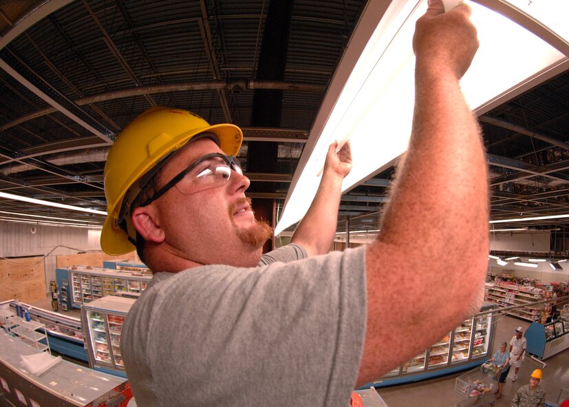 DYESS AIR FORCE BASE, Texas -- Leland Miller replaces a fluorescent light bulb at the commissary, June 11. Leland is part of the construction team during the commissary renovation, which is scheduled to be completed in the summer of 2009. (U.S. Air Force Photo by Airman 1st Class Stephen Reyes)
