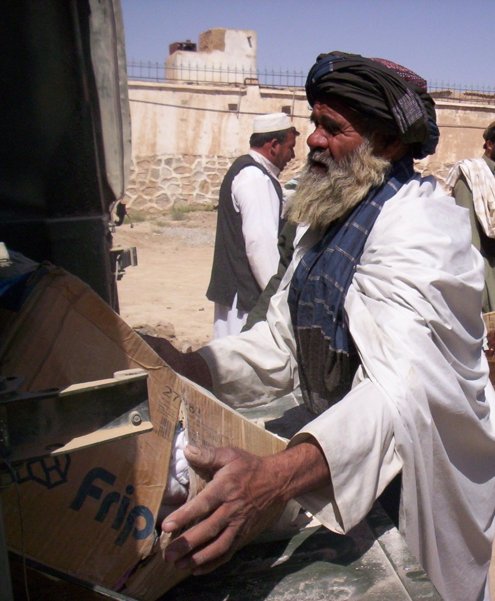 ZABUL PROVINCE, Afghanistan -- A Jarullah village elder helps unload food, healthcare supplies and clothing to be organized and distrubuted. The Zabul Provincial Reconstruction Team visited the village to assess needs for additional wells and provide village elders with supplies needed in their village.  (U.S. Air Force photo by Capt. Jean Duggan)