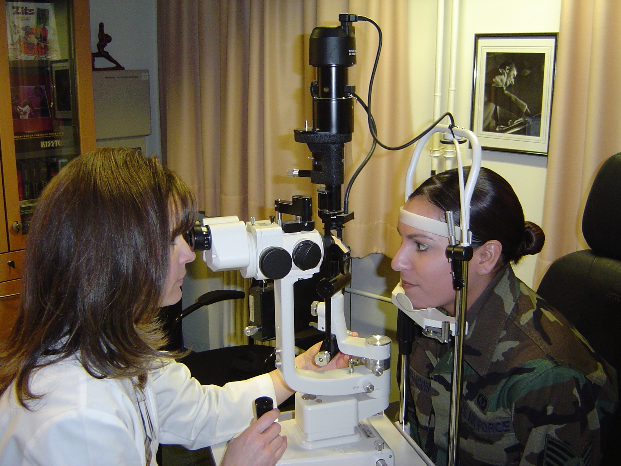 SPANGDAHLEM AIR BASE, Germany -- Dr. Susan Sabers, Red Cross volunteer and optometrist, examines a patient. Since 2005, she examined more than 1,400 patients as a 52nd Aerospace Medicine Squadron volunteer, saving the Air Force nearly $142,000 in outsourcing costs to civilian physicians. Courtesy photo 