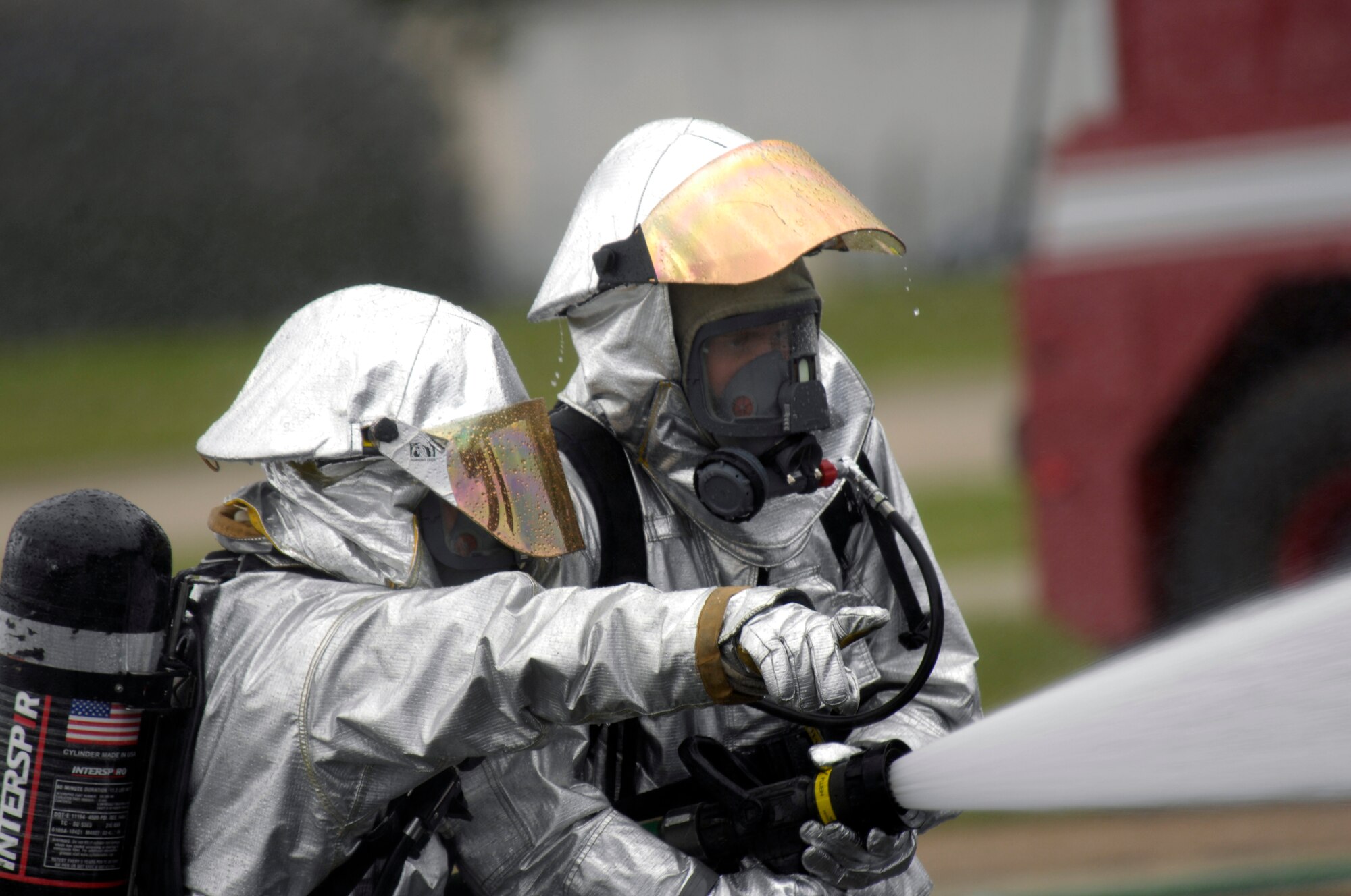 Firefighter's from the 48th Civil Engineer Squadron extinguish a fire on a simulated F-15C crash, Jun 12 at RAF Lakenheath. Firefighters are one of the first responders to the scene. (U.S. Air Force photo by Airman Perry Aston) 