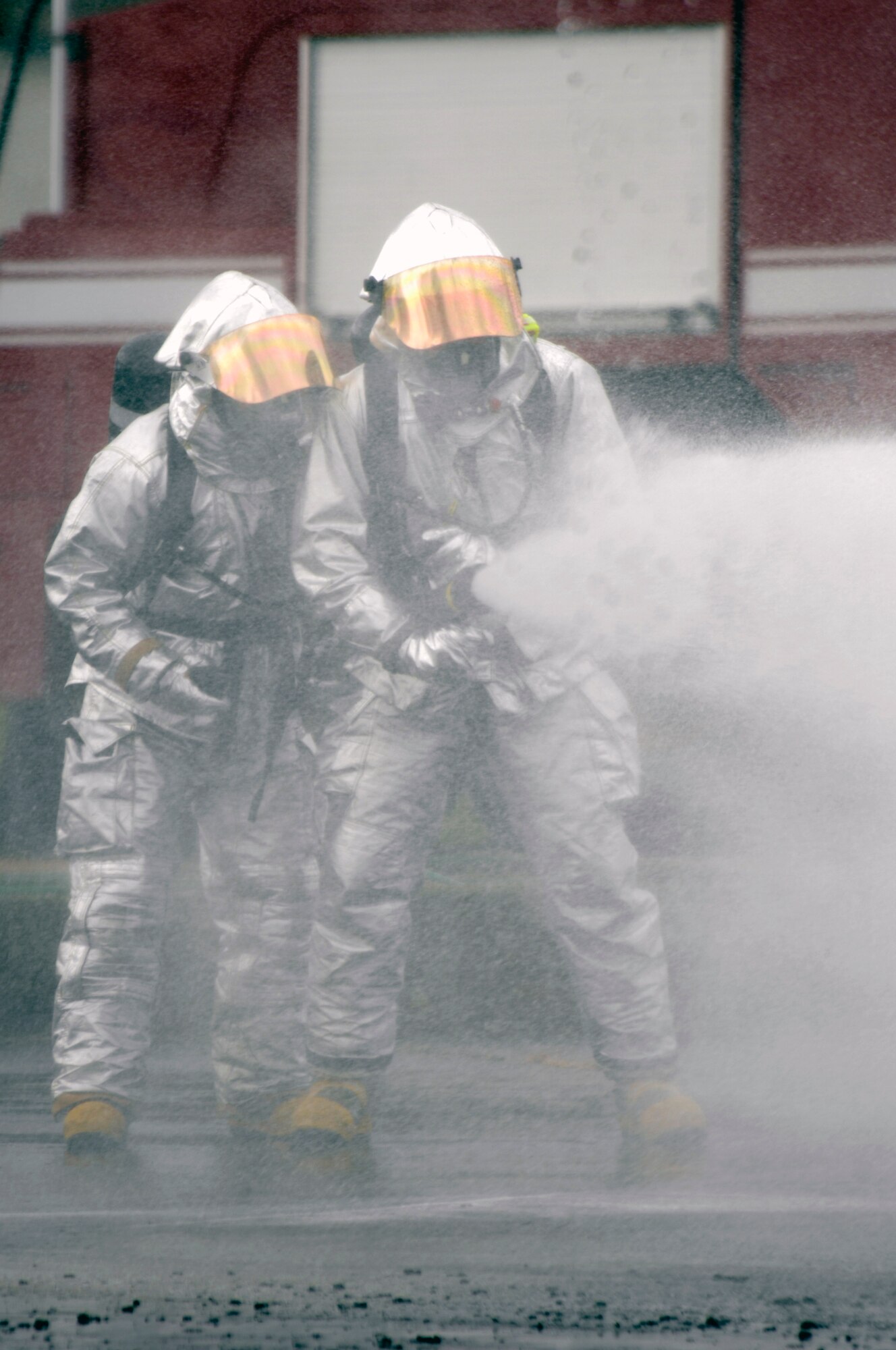 Firefighter's from the 48th Civil Engineer Squadron extinguish a fire on a simulated F-15C crash, Jun 12 at RAF Lakenheath. Firefighters are one of the first responders to the scene. (U.S. Air Force photo by Airman Perry Aston) 